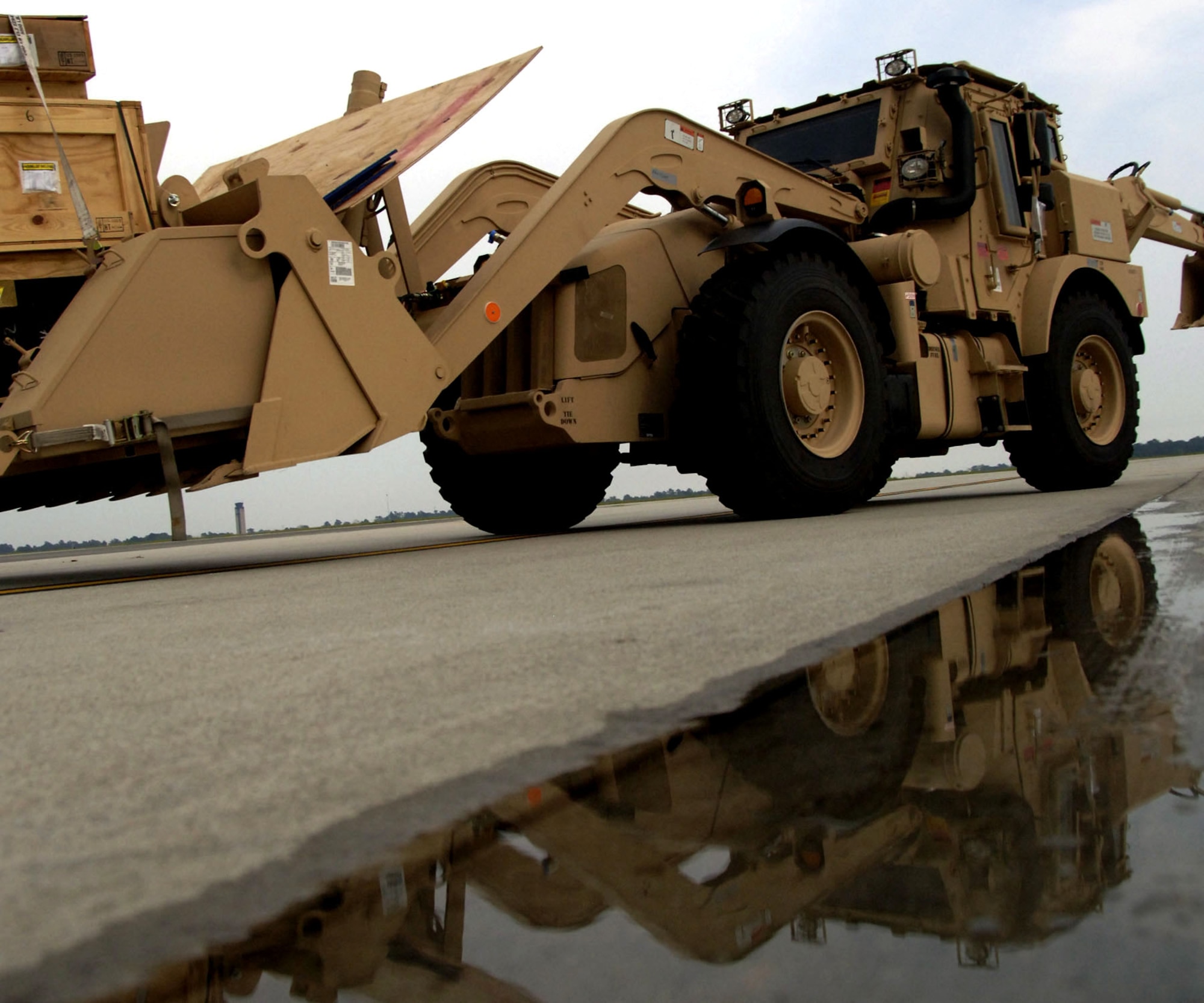 An Army High Mobility Engineer Excavator is moved into position prior to being loaded onto a C-5 Galaxy Sept. 29 at Charleston Air Force Base, S.C. The HMEEs will be transported to forward deployed locations to assist Soldiers and contractors in hostile environments. (U.S. Air Force photo/Airman 1st Class Timothy Taylor)
