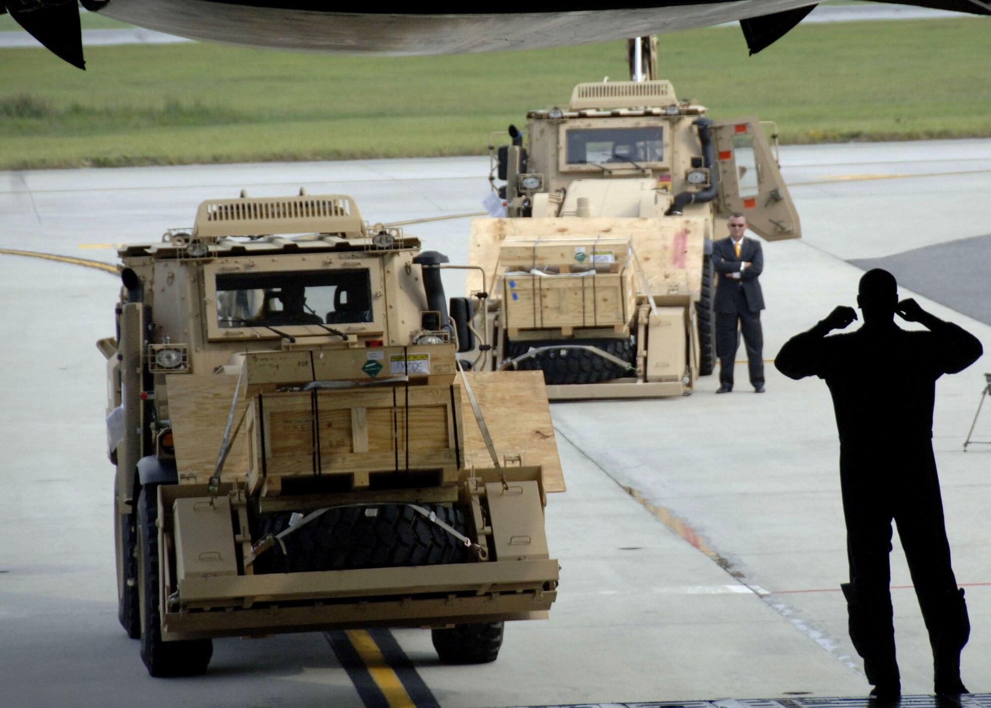 An Airman from the Memphis Air National Guard guides an Army High Mobility Engineer Excavator into the back of a C-5 Galaxy Sept. 29 at Charleston Air Force Base, S.C. Charleston AFB is the first Air Force base to help in aiding in transporting the vehicles to forward deployed Soldiers and contractors in hostile environments. The HMEE is a newly developed military construction vehicle capable of a wide range of mobility affording more protection for the operator than conventional excavators. (U.S. Air Force photo/Airman 1st Class Timothy Taylor) 
