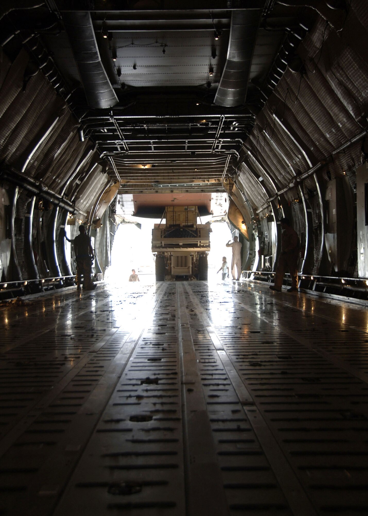 An Army High Mobility Engineer Excavator is loaded onto a C-5 Galaxy Sept. 29 at Charleston Air Force Base, S.C. Airmen helped transport the vehicles to forward deployed Soldiers and contractors in hostile environments. The HMEE is a newly developed military construction vehicle capable of a wide range of mobility affording more protection for the operator than conventional excavators. (U.S. Air Force photo/Airman 1st Class Timothy Taylor)
