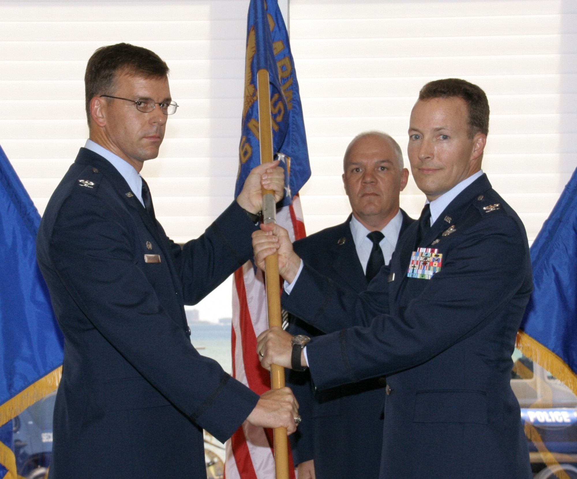 Col. Bruce McClintock, 96th Air Base Wing commander, passes the 96th Mission Support Group flag to Col. Alan Bridges in an assumption of command ceremony Oct. 2. (USAF photo by Master Sgt. Franklin Mckinney)