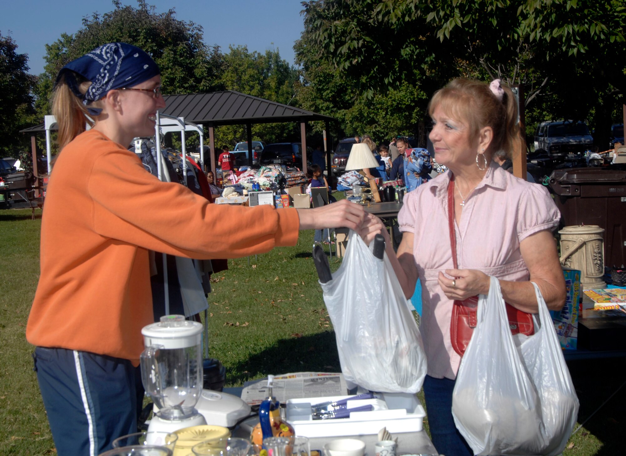 Becky Wiley (right) receives a bag of good from Amy Schillinger (left) at the base-wide garage sale Saturday on Scott. The garage sale that’s held monthly allows families to purchase other peoples’ “treasures” that are no longer needed. The sale that’s held every 3rd Saturday draws huge crowds in search for that hidden treasure.
(U.S. Air Force photo/Tech. Sgt. Michelle Larche)

