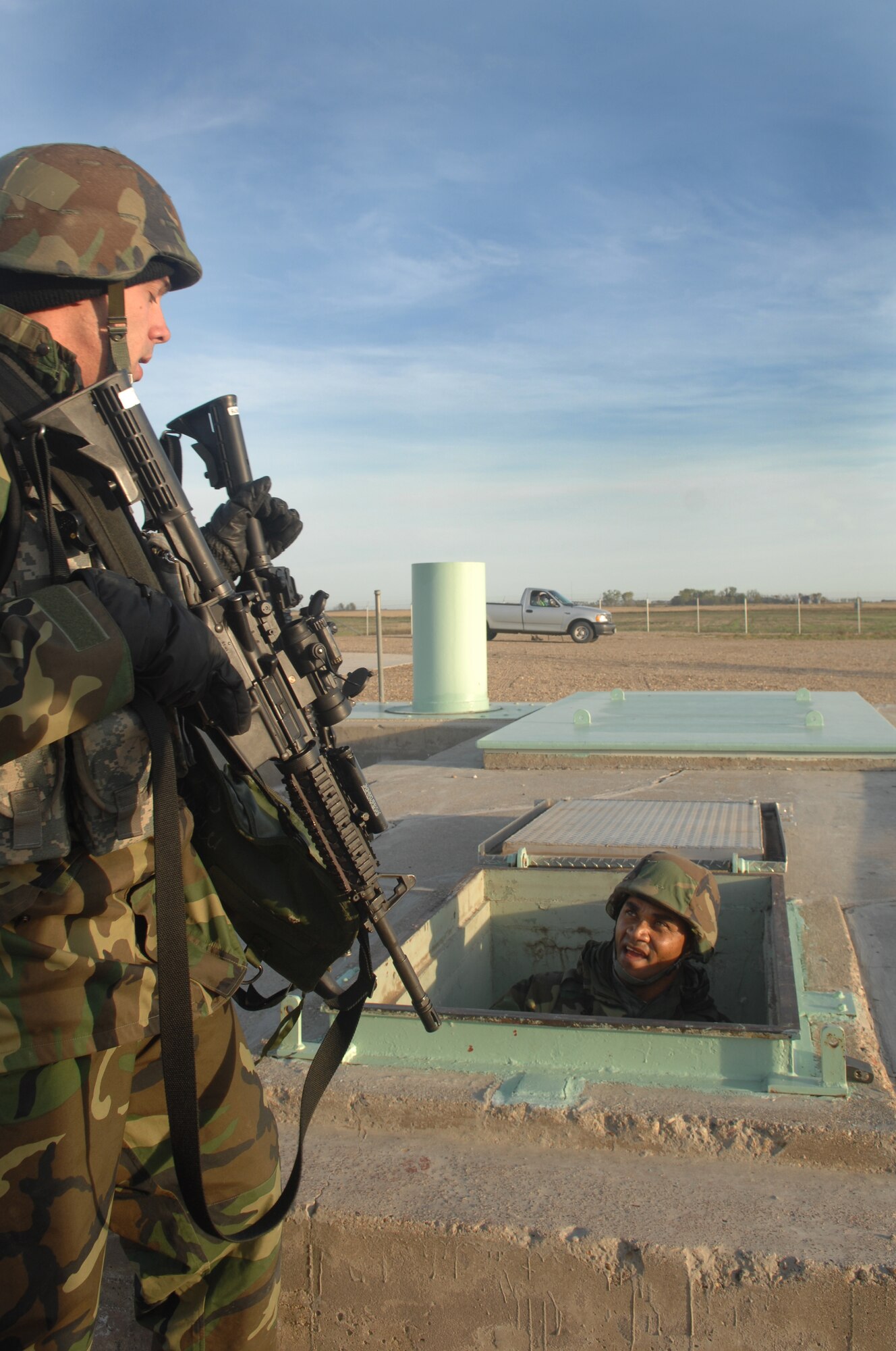 MINOT AIR FORCE BASE, N.D. -- 1st Lt. Jared Brush and Tech. Sgt. Duke McDuffie, 91st Missile Security Forces Squadron, complete a simulated sweep of a missile silo during a recap exercise at a Launch Facility here Sept. 25. The exercise was conducted to test the 91st Security Forces Group’s ability to respond to the invasion of controlled areas. (U.S. Air Force photo by Senior Airman Stacy Moless)