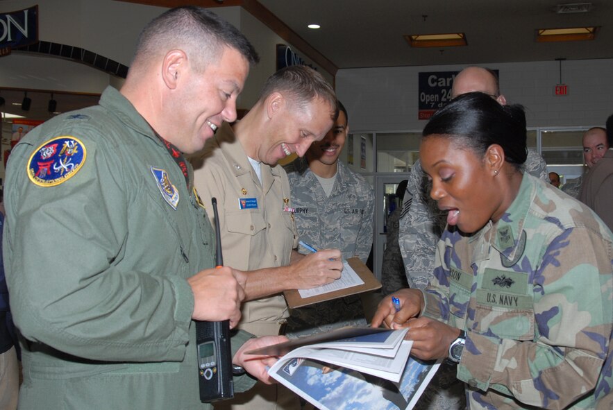 MISAWA AIR BASE, Japan -- Col. Mark Altobelli, 35th Operations Group commander, and Navy Capt. James Haugen, Naval Air Facility Misawa commander, joke with Petty Officer 1st Class Thelma Gibson, NAF Misawa, during the annual Combined Federal Campaign kick-off ceremony Oct. 1, 2008. The CFC runs through Nov. 30 and is the only authorized solicitation of federal employees in the workplace on behalf of charitable organizations. (U.S. Air Force photo by Senior Airman Laura McFarlane)