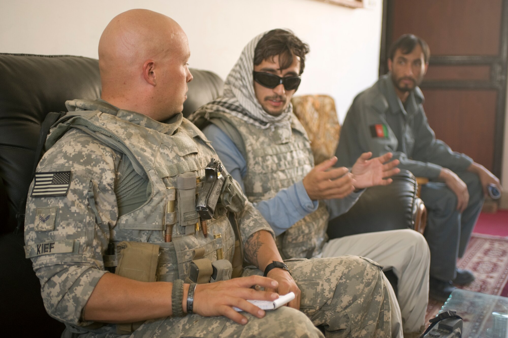 BAGRAM AIR FIELD, Afghanistan – Senior Airman Andrew Kief, a Kapisa and Parwan Provincial Reconstruction Team security forces member, takes notes during a meeting with members of the Afghan National Police force.  As a member of the PRT police technical assistance team, Airman Kief helps coach, mentor and train ANP forces in security responsibilities to the citizens of Afghanistan. Airman Kief is deployed from 56th Security Forces Squadron at Luke Air Force Base, Ariz. (U.S. Air Force photo/Master Sgt. Keith Brown) 