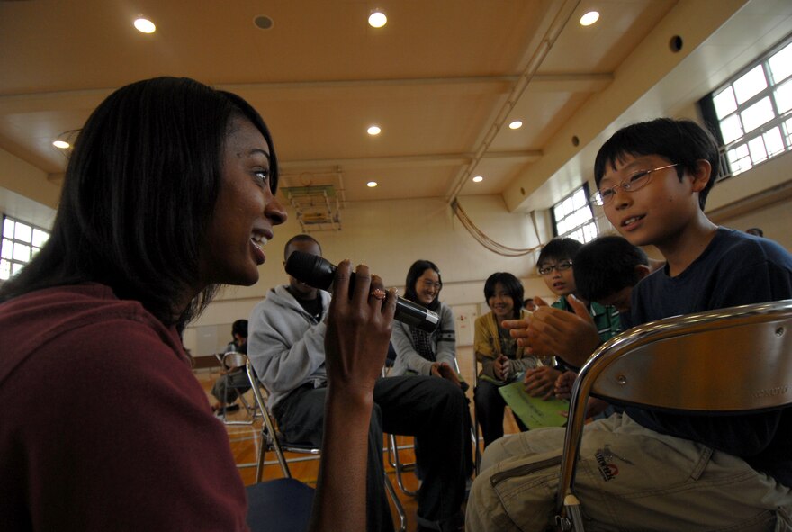 YOKOTA AIR BASE, Japan -- Staff Sgt. Felita Rowe from the Pacific Forces Band, sings to Gota Hosobuchi, a sixth grader from the Fourth Elementary school in Fussa, Japan, during a visit to his school Sept. 30. The elementary school invited approximately 30 military members from Yokota to come and take part in events that they learn throughout their school day.(U.S. Air Force photo by Senior Airman Laszlo Babocsi)(Released)