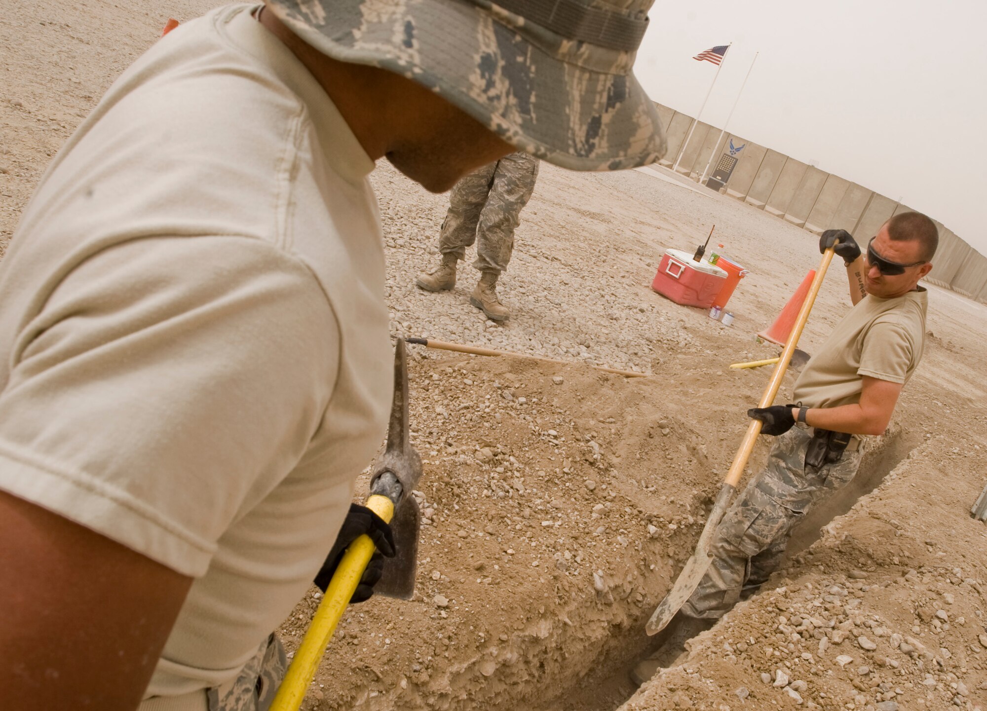 ALI BASE, Iraq -- In attempt to return the base to the Iraqi military in better condition when leaving, the 407th Expeditionary Civil Engineer Squadron Utilities Shop Airmen dig trenches for water and sewer lines Oct. 1, 2008. (U.S. Air 
Force photo/Airman 1st Class Christopher Griffin)