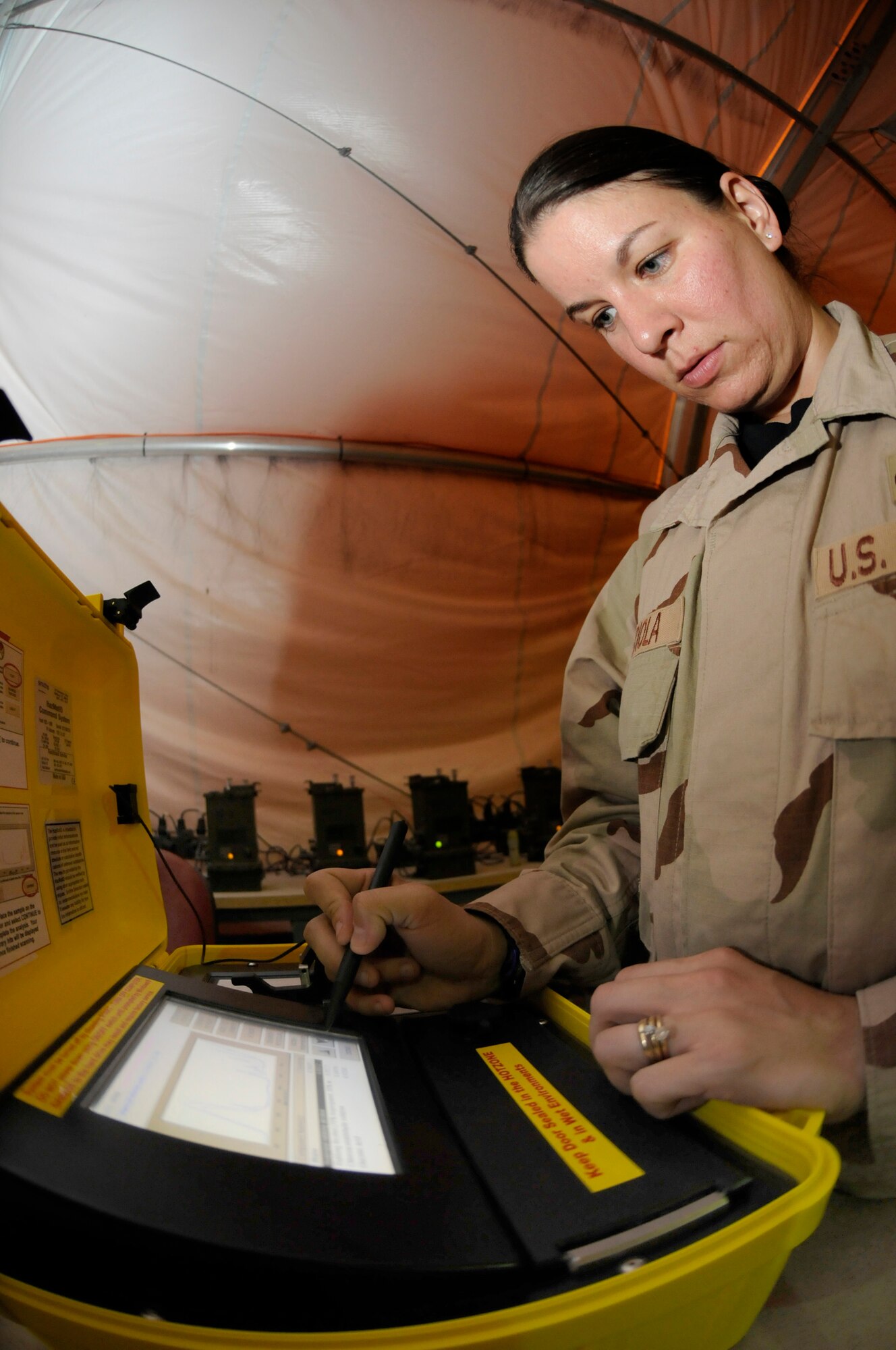 Staff Sgt. Heather Mendiola, non-commissioned officer in charge of emergency management logistics assigned to the 379th Expeditionary Civil Engineer Squadron, performs an operational check on a hazardous material identifier Oct. 1, 2008, at an undisclosed air base in Southwest Asia. The equipment is used to produce a presumptive identification of liquid, powder, or solid hazardous materials so emergency management can provide instruction on what type of protective gear is required. Sergeant Mendiola, a native of New Castle, Del., is deployed from Anderson Air Base, Guam, in support of Operations Iraqi and Enduring Freedom and Joint Task Force-Horn of Africa. (U.S. Air Force photo by Staff Sgt. Darnell T. Cannady/Released)