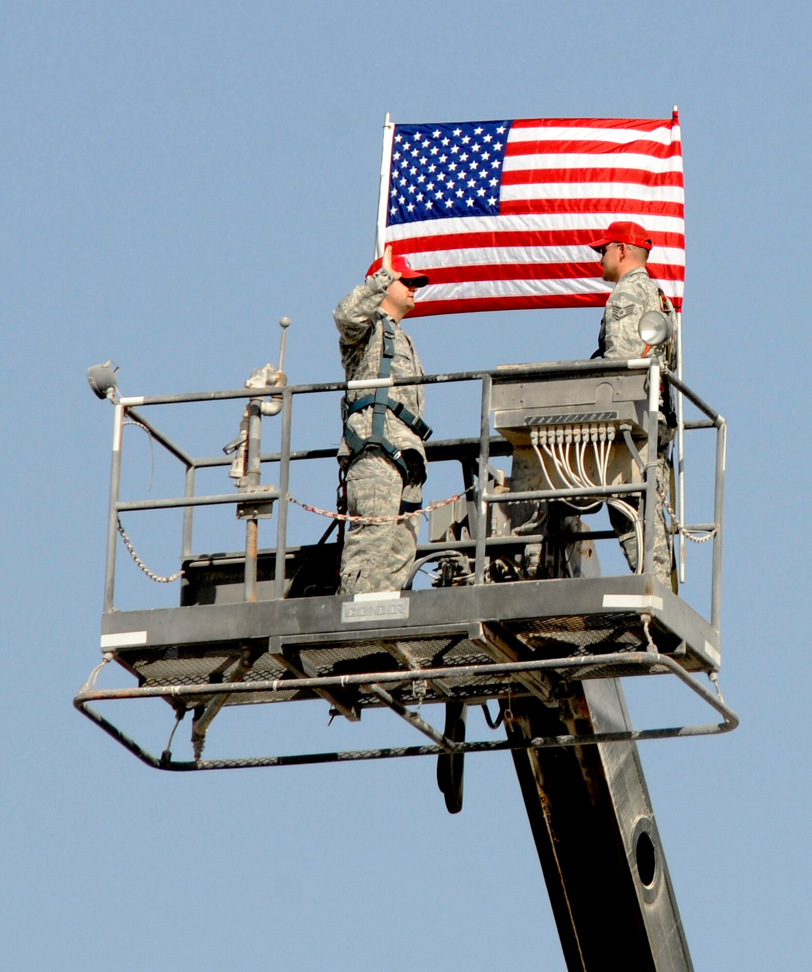 Staff Sergeant Jarrett Gordon, 1st Expeditionary Rapid Engineer Deployable Heavy Operational Repair Squadrons Engineer (RED HORSE) Group, reenlists high over the base October 1, 2008.  Maj. Steven Blake, Commander, 1st Expeditionary RED HORSE Group, officiates the ceremony at an undisclosed location in Southwest Asia.  RED HORSE units possess special capabilities, such as GeoReach remote bed down planning, water-well drilling, explosive demolition, quarry operations, material testing, expedient facility erection, and concrete and asphalt paving. Sergeant Gordon is a native of Magalia, Calif., and is deployed from Barksdale, Air Force Base, La.  Maj. Blake hails from Dallas, Texas, and is deployed from Hurlburt Field, Fla.  Both are deployed in support of Operations Iraqi and Enduring Freedom and Joint Task Force-Horn of Africa.  (U.S. Air Force photo by Tech. Sgt. Michael Boquette/Released)