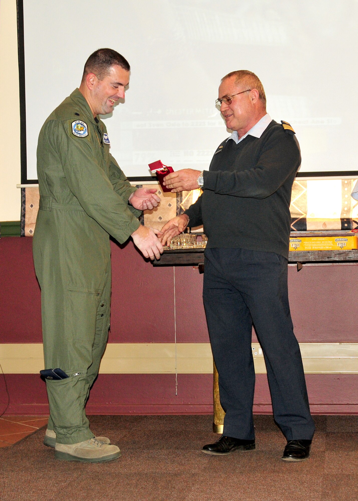 United States Air Force Lt. Col Mark August, 37th Airlift Squadron commander, Ramstein Air Base, Germany, accepts a gift from Col. Herman Olmesdahl, 28th Squadron commander, Ysterplaat Air Force Base, South Africa, Sept. 22, 2008. (U.S. Air Force photo by Staff Sgt. Markus Maier)(Release)