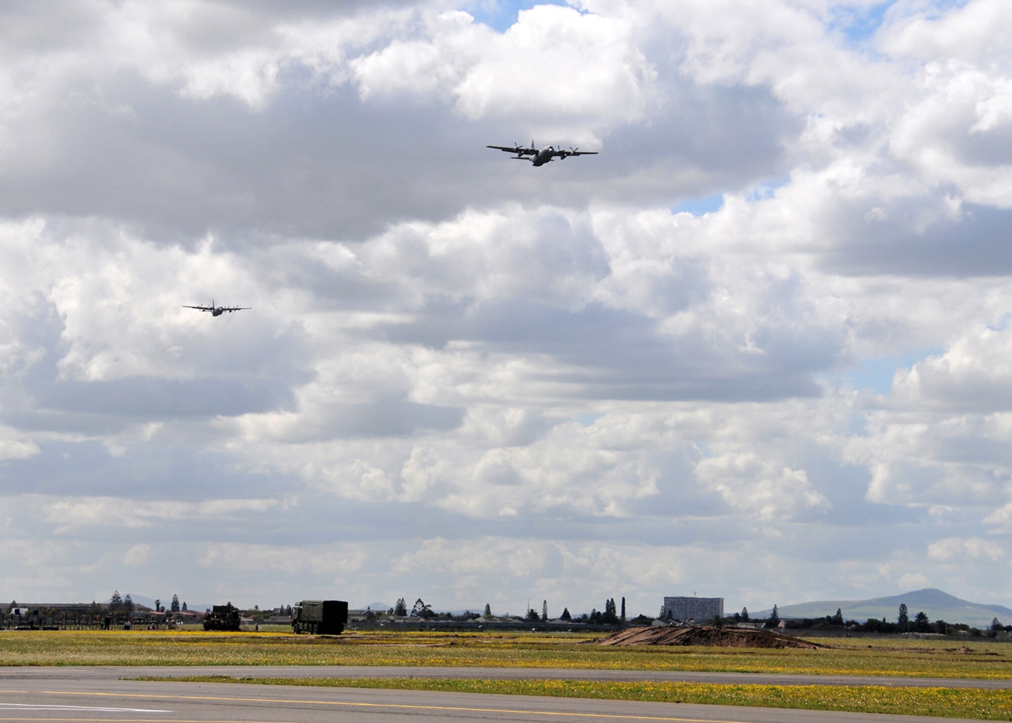 Two U.S. Air Force C-130s from the 37th Airlift Squadron, Ramstein Air Base, Germany, perform a fly-over at the 2008 Africa Aerospace & Defense Air Show, Ysterplaat Air Force Base, South Africa, Sept. 18, 2008. (U.S. Air Force photo by Staff Sgt. Markus Maier)(Release)