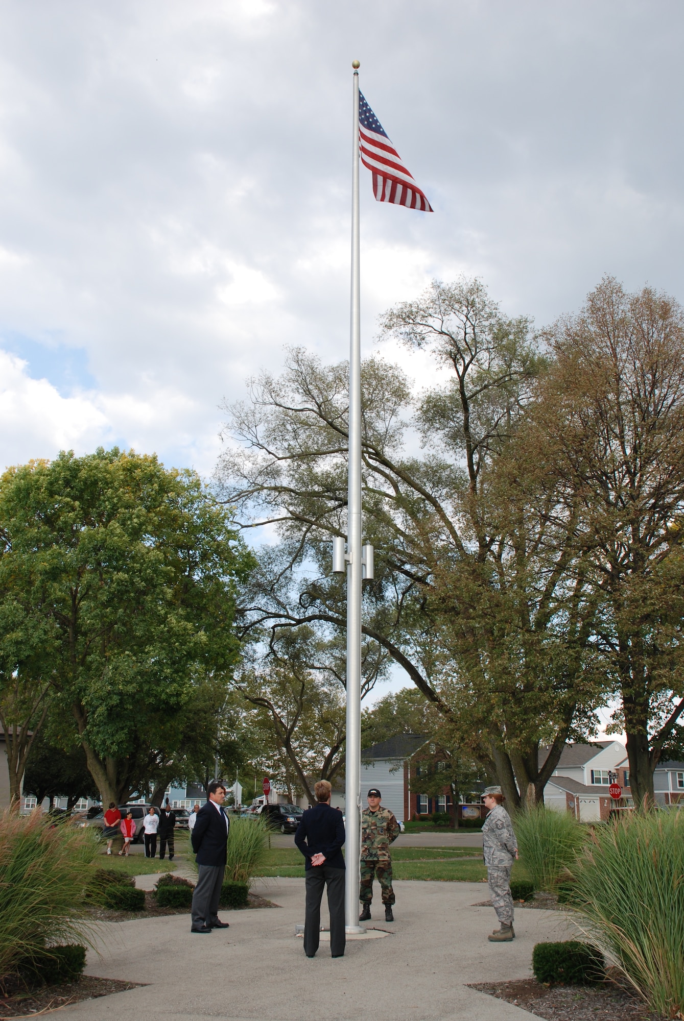 A four-member military-civilian flag detail prepares to lower the American flag at The Prairies at Wright Field on Sept. 30. Team members from left are Dr. Nicholas J. DelRaso, Dr. Camilla A. Mauzy, Major Leamon K. Viveros and Master Sergeant Julie A. Boyer. (U.S. Air Force photo/Chris Gulliford)