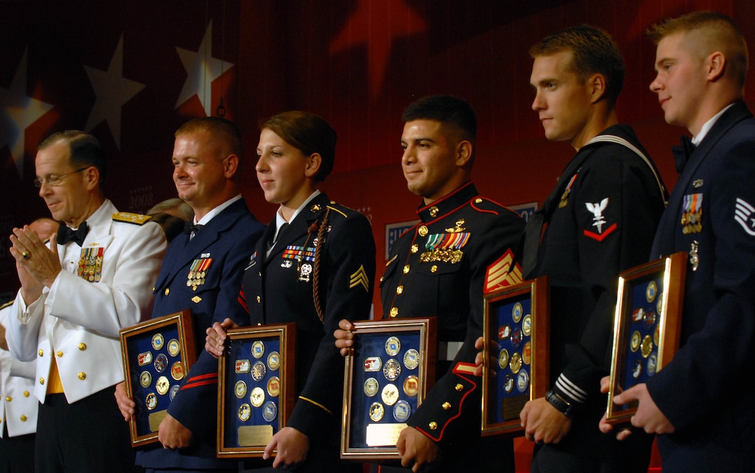 Navy Adm. Mike Mullen, chairman of the Joint Chiefs of Staff (left), applauds the five servicemembers United Service Organizations honored at its 2008 USO World Gala in Washington on Oct. 1, 2008. The honorees are Coast Guard Petty Officer 1st Class Phillip N. Waldron (second from left), Army Spc. Monica L. Brown, Marine Sgt. Richard E. Reyes, Navy Petty Officer 3rd Class Joshua E. Simson and Air Force Staff Sgt. Shawn A. Ryan. USO chose each of the servicemembers as its servicemember of the year for their respective services. DoD photo by Samantha L. Quigley