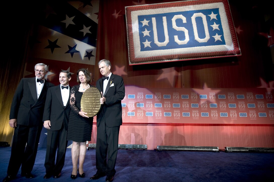 USO Chairman of the World Board William G. Moll, current USO President and CEO Sloan D. Gibson and outgoing President and CEO USO Edward A. Powell present 2008 Spirit of the USO to Jeanne Vander Myde Warner in honor of her husband, Virginia Sen. John Warner at the USO World Gala, Marriott Wardham Park Hotel, Washington, D.C., Oct. 1, 2008.