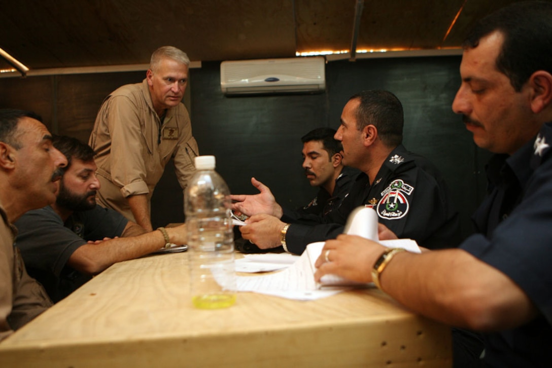 Col. Shaban Barzan Himrin (middle-right), Baghdadi, Iraq, chief of police, who is often called the "Lion of al-Anbar," conducts a mock interview during the Law Enforcement Program course at Camp Ripper, Iraq, Oct. 2. Members of the LEP put on the course Oct. 1-2 to teach Iraqi Security officers to create, supervise and lead new Iraqi law enforcement teams around al-Anbar province, Iraq. â??We swear to God we will follow criminals wherever they go and do whatever it takes to catch them,â? said Shaban to the class. â??The people in the area are counting on you.â?::r::::n::