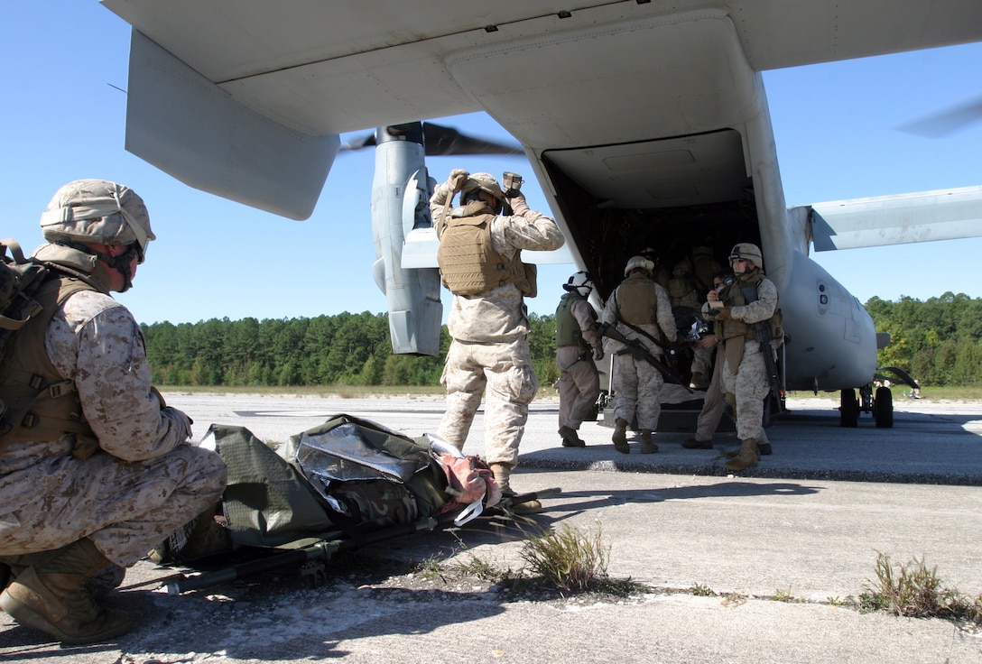 Marines and sailors from Combat Logistics Battalion 22, 22nd Marine Expeditionary Unit, load role players on an MV-22 Osprey from Marine Medium Tiltrotor Squadron 263 (Reinforced) during a massive casualty exercise Oct. 2, 2008, aboard Fort Pickett, Va., a Virginia Army National Guard Maneuver Training Center. The exercise was part of the CLB's off-site training, the first major evolution of the 22nd MEU's six-month pre-deployment training cycle. The 22nd MEU is scheduled to deploy next spring. (Official Marine Corps photo by Staff Sgt. Matt Epright)::r::::n::