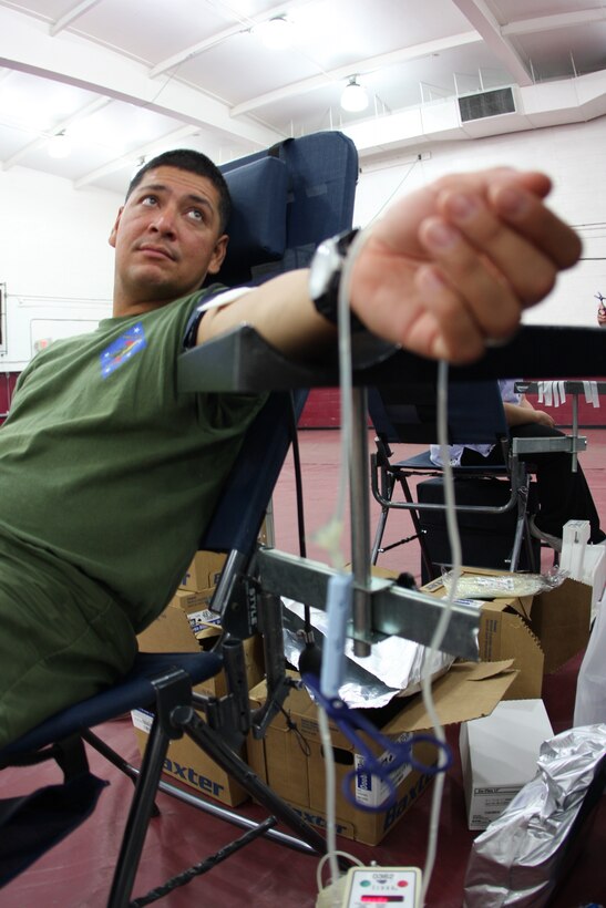 Staff Sgt. John Parker, tank mechanic, Headquarters and Support Company, 1st Tank Battalion, waits his turn to give blood at a Community Blood Bank drive at the West Gym Friday.