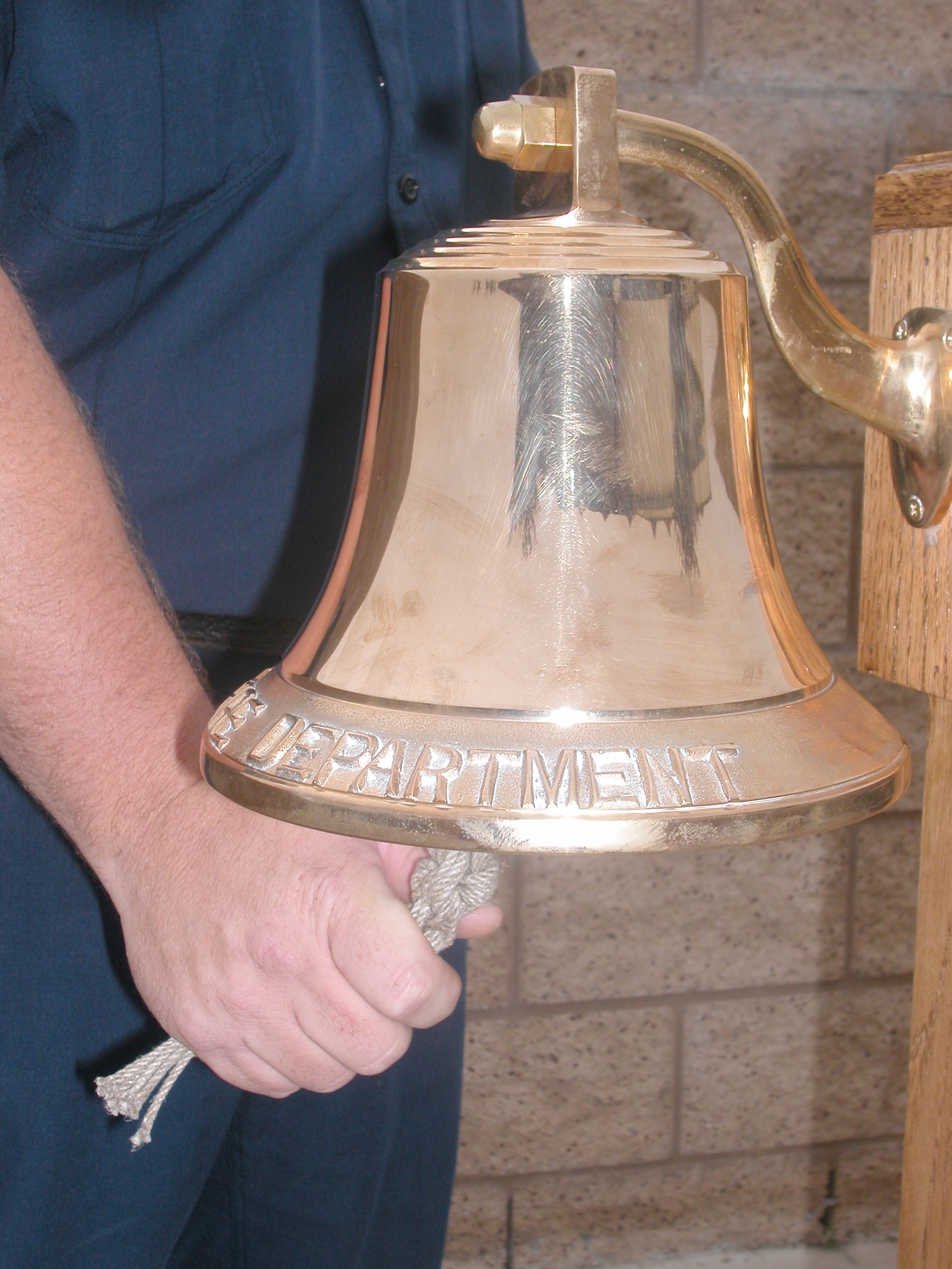 BELL RINGER: Capt. Chris Christianson rings a bell in three sets, five times per set, at a ceremony at the March ARB Fire Department, Sept. 11.  (U.S. Air Force photo by Will Alexander, 452 AMW/PA) 