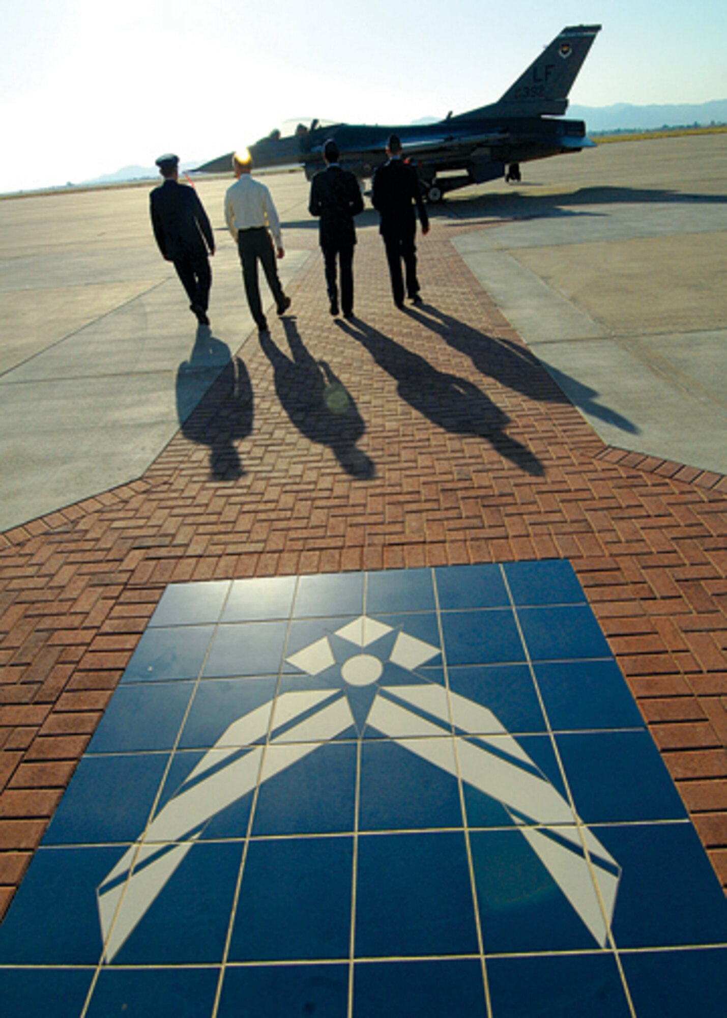 Donald "Don" Luke, nephew of Lt. Frank Luke Jr., Luke AIr Force Base's namesake, is accompanied to the F-16 Fighting Falcon that was dedicated to Lieutenant Luke on Monday in remembrance of the 90th anniversary of his death. (U.S. Air Force Photo/Tech. Sgt. Jeffery Wolfe.)