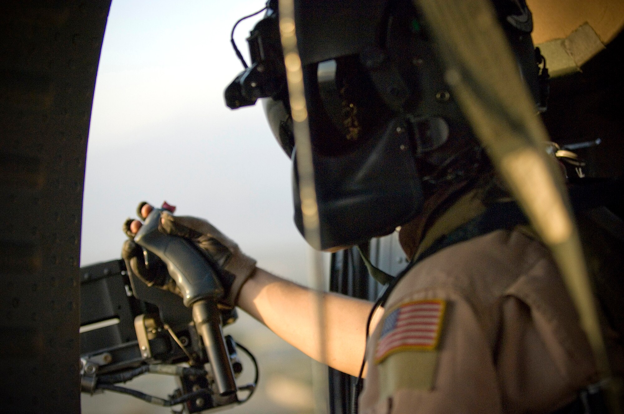 Senior Airman Chris Bridges scans the horizon for any threats during a combat search and rescue mission on board an HH-60G Pave Hawk Sept. 25 near Bagram Airfield, Afghanistan. Airmen of the 33rd Expeditionary Rescue Squadron conducted training for integrated operations with the Army's AH-64 Apache for combat search and rescue missions in high threat environments. Airman Bridges is a HH-60G gunner for the 33rd Expeditionary Rescue Squadron. (U.S. Air Force photo/Staff Sgt. Rachel Martinez) 
