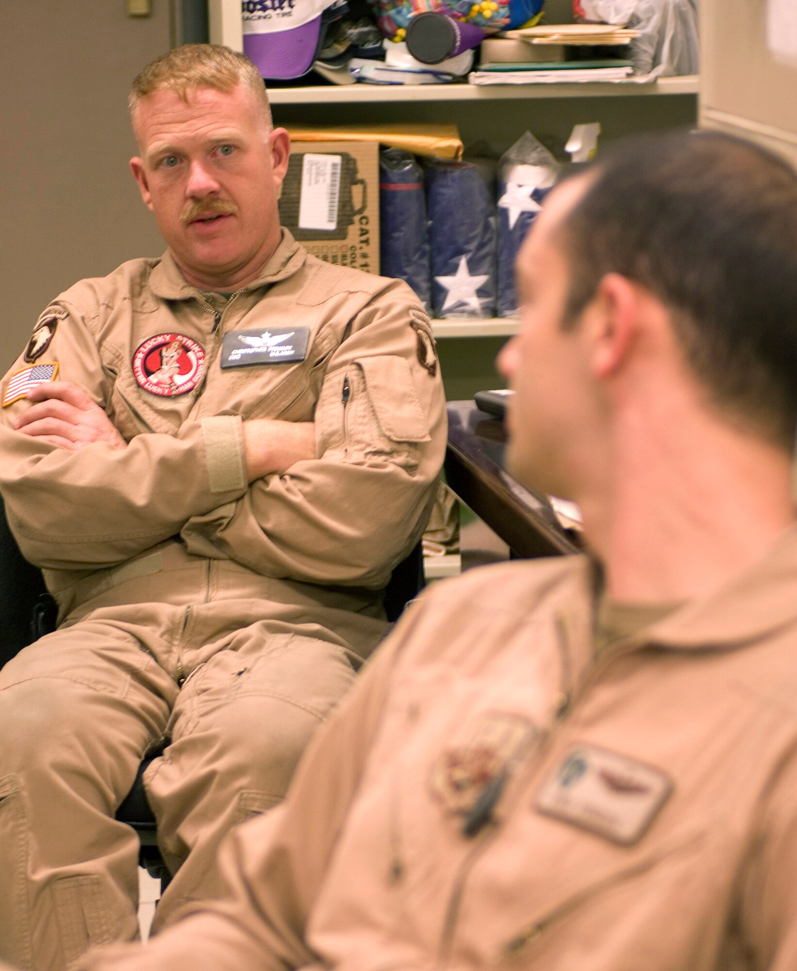Army Chief Warrant Officer Christopher Stewart debriefs a joint training mission with Capt. Ryan Voneida Sept. 26 at Bagram Airfield, Afghanistan. Mr. Stewart is an AH-64 Apache pilot, and Captain Voneida is an HH-60G Pave Hawk pilot assigned to the 33rd Expeditionary Rescue Squadron. (U.S. Air Force photo/Staff Sgt. Rachel Martinez) 