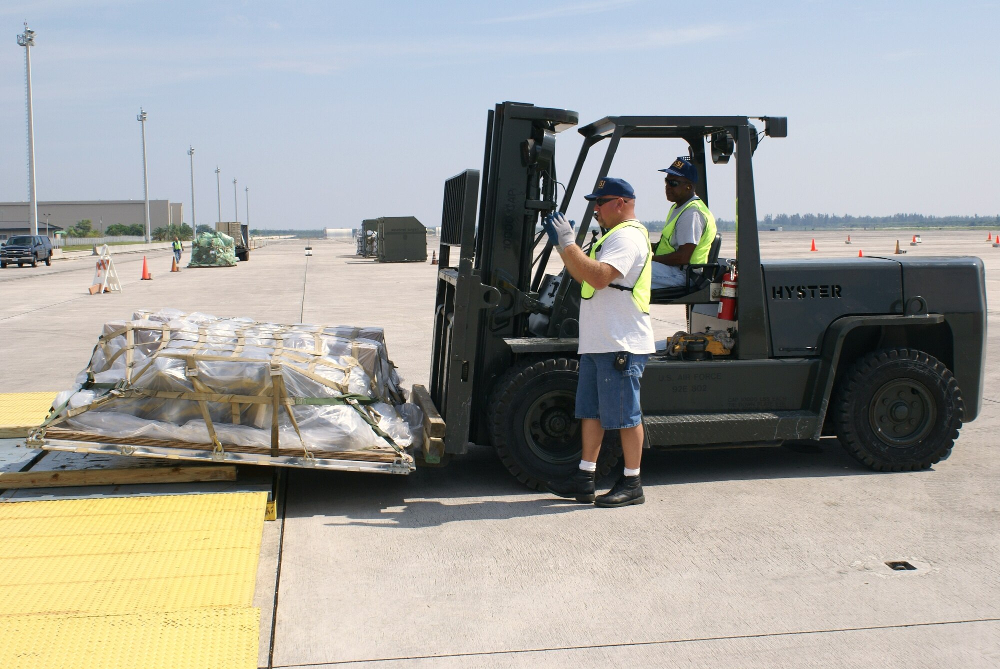 Mr. Michael Smothers and Mr. Morris Maxwell, Cargo Deployment Function, Satellite Services Inc., prepare to weigh a pallet during the 482nd Fighter Wing phase 1 mobility exercise on Oct. 3.  The three day exercise is conducted each year to evaluate the wing’s transition from peacetime readiness into a wartime posture, test the wing’s installation deployment plan and help Airmen hone their skills. (U.S. Air Force photo/Tim Norton)