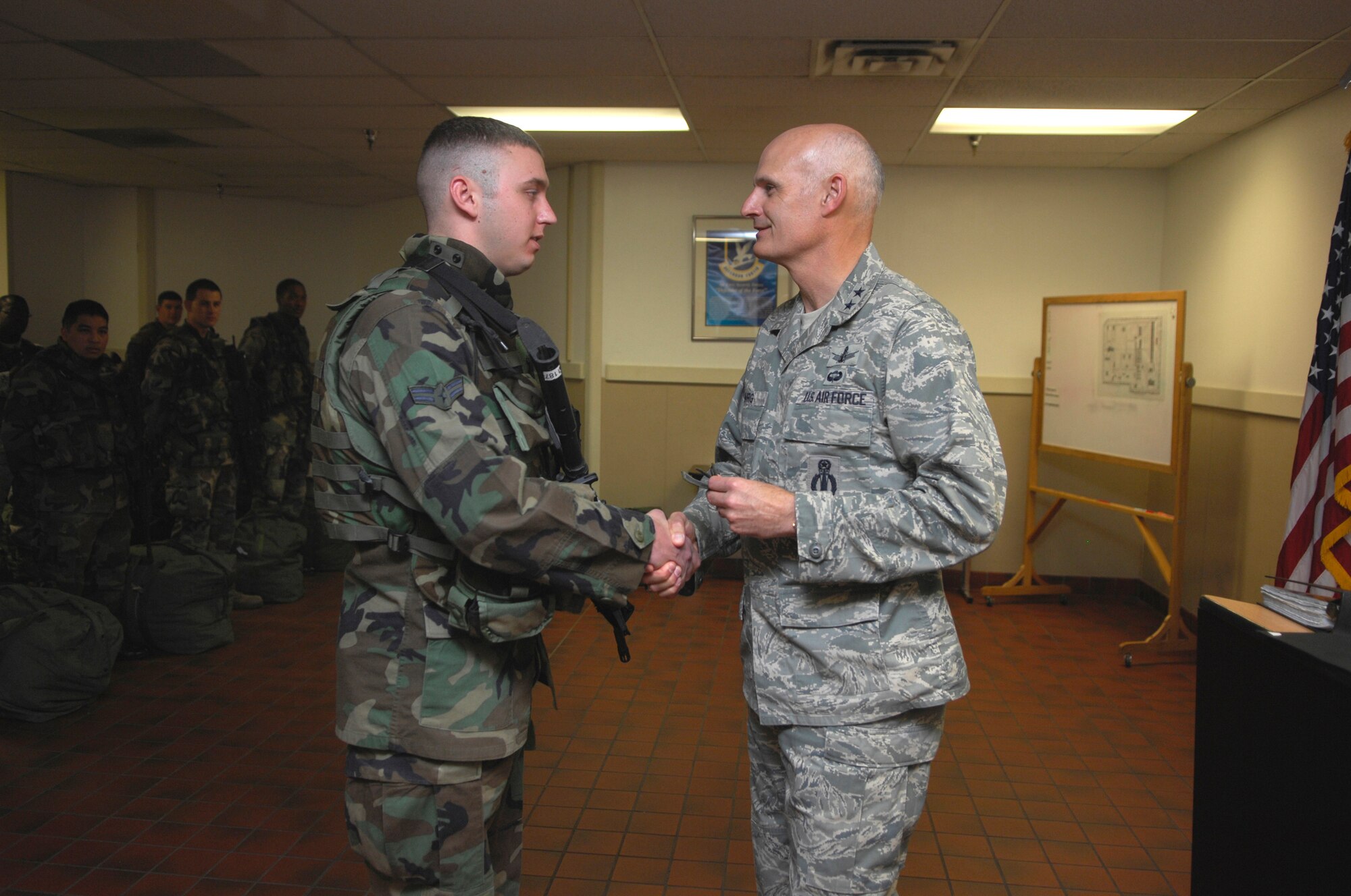 MINOT AIR FORCE BASE, N.D. -- Major General Roger Burg, 20th Air Force Commander, presents Airman 1st Class Caleb Medley with Senior Airman Chevrons for a below-the-zone promotion. Airman Medley is a response-force leader assigned to the 91st Missile Security Forces Squadron. (U.S. Air Force photo by Senior Airman Joe Rivera)