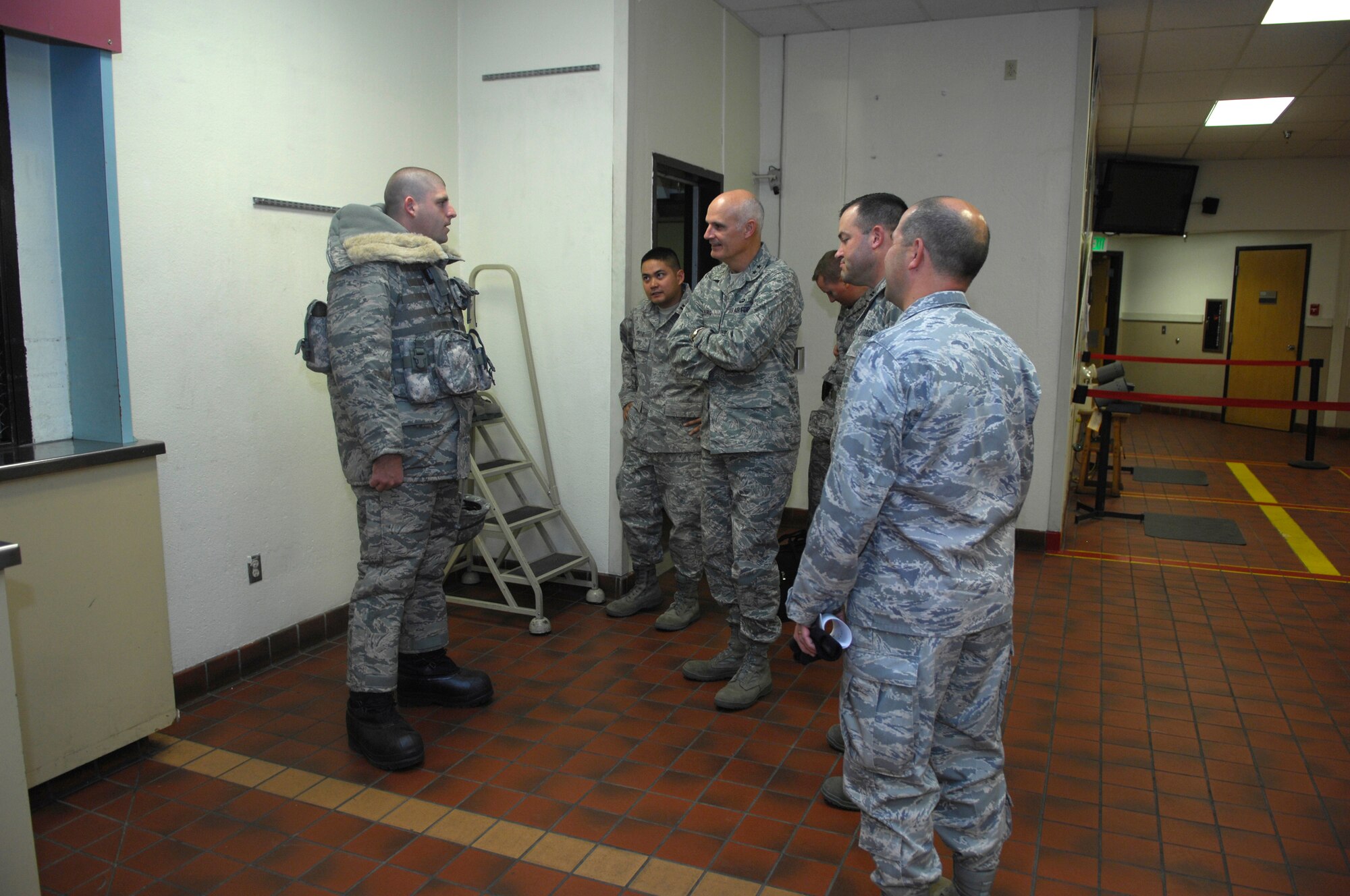 MINOT AIR FORCE BASE, N.D. -- Senior Airman Corin Dolson, 91st Security Forces Support Squadron, demonstrates to Major General Roger Burg, 20th Air Force commander, a new uniform idea to help security forces here, Oct. 2. The cold weather uniform will improve the quality of response in adverse weather conditions for security forces by allowing them to maneuver more tactually, using lightweight cold weather gear while not sacrificing safety from the extreme cold weather. (U.S. Air Force photo by Senior Airman Joe Rivera)