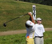 Officer trainee Justin Ailor helps with crowd control Saturday at the Navistar LPGA Classic as Seon Hwa Lee of South Korea tees off the 14th hole of the Senator Course at Robert Trent Jones Golf Trail's Capitol Hill location. (Air Force photo by Master Sgt. Scott Moorman)