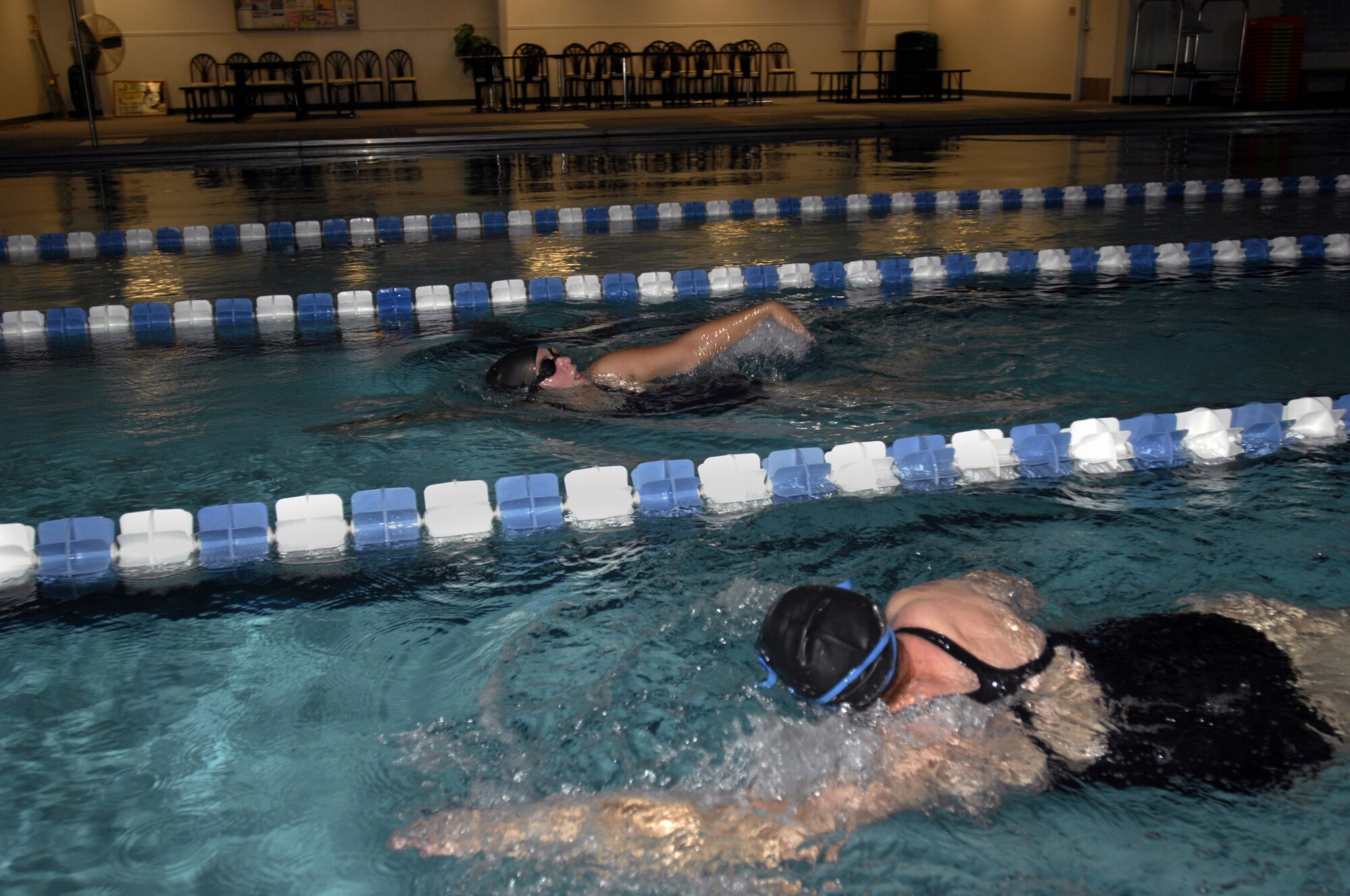 MINOT AIR FORCE BASE, N.D. — Katy Peterson and Susan Peterson swim laps as part of their weekly workout in the indoor pool located at the McAdoo Sports and Fitness Center here at Oct. 1. The fitness center’s indoor pool is available for open swimming reservations by individuals, groups, or squadrons. (U.S. Air Force photo by Airman 1st Class Jesse Lopez)