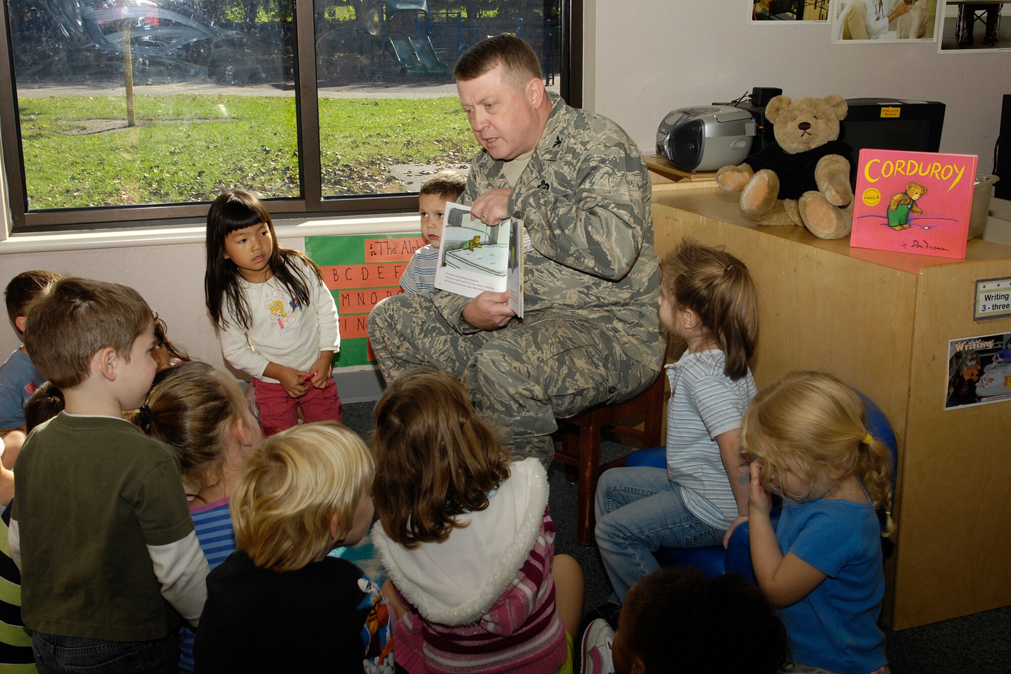 HANSCOM AFB, Mass. – Col. Jeffrey Mayo, 66th Air Base Wing vice commander, reads to children in Room 8 at the Child Development Center on Oct. 2, as part of Jumpstart’s national Read for the Record campaign. The campaign is designed to bring attention to the importance of early education by encouraging hundreds of thousands of children and adults to read the same book on the same day. USO New England donated copies of the book Corduroy to children enrolled in the CDC’s pre-school program as part of the Read for the Record campaign. (U.S. Air Force photo by Linda LaBonte Britt)