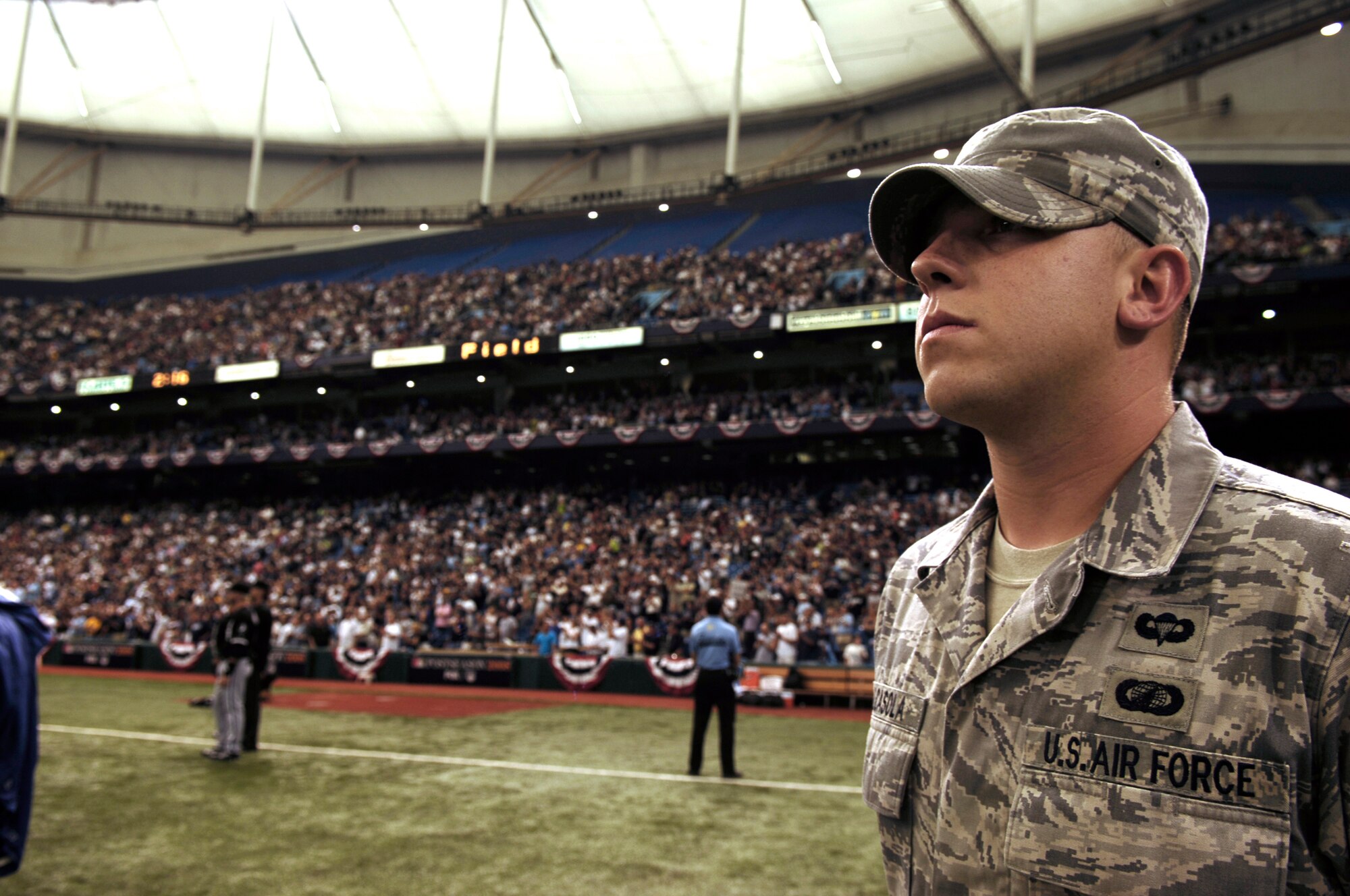 Senior Airman Jamie Calcasola, 6th Contracting Squadron, stands at attention on the field before the beginning of the Tampa Bay Ray's Amercian Division League Series playoff game against the Chicago White Sox Oct. 2. 6th Air Mobility Wing Airmen along members of the U.S. Coast Guard assigned to sector St. Petersburg, Fla., participated in the game's opening ceremony. The Rays invited all military members who participated in the ceremony to stay and watch the Ray?s first ever playoff game in franchise history. MacDill Air Force Base and the Tampa Bay Ray?s have both formed a great community involvement relationship since the team?s creation in 1998.  The Ray?s, the American League East Champions, beat the Chicago White Sox six to four in game one of the best-of-five playoff series.  (Air Force photo by Tech Sgt Sean Mateo White)
