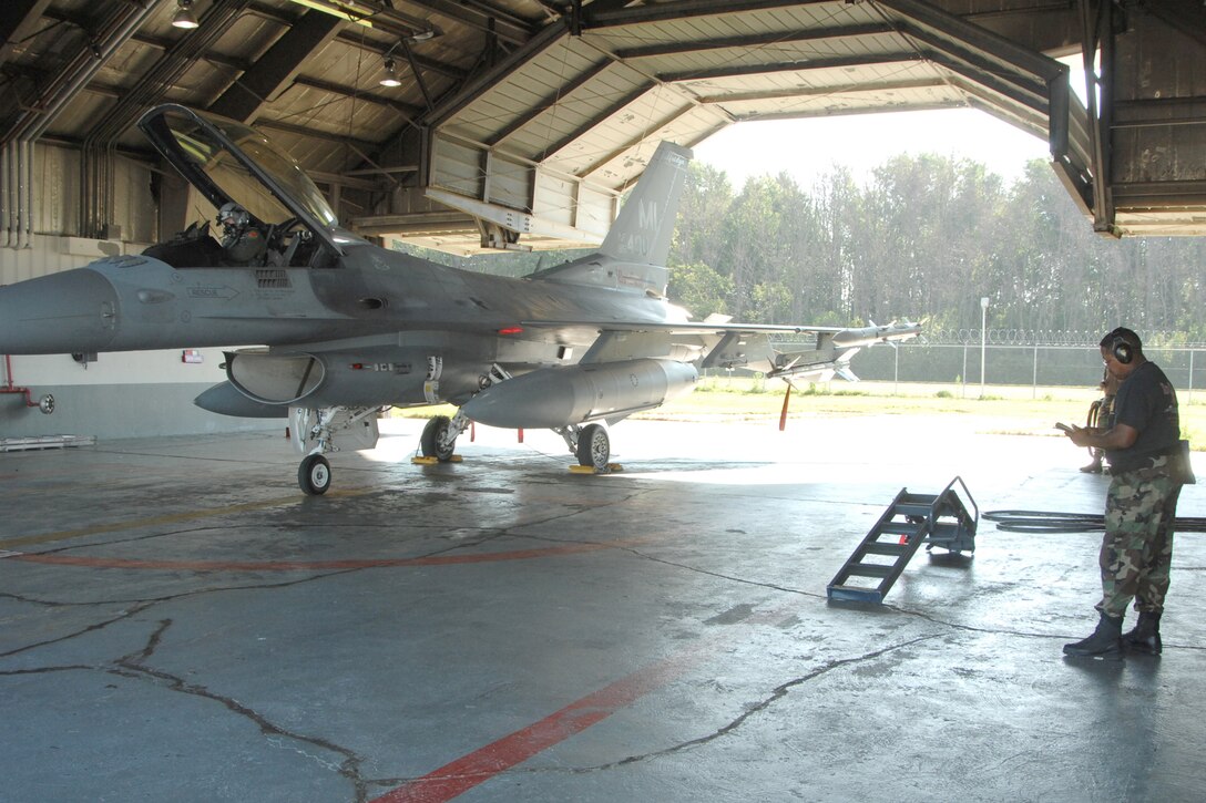 F-16 Pilot Lt. Col. William Hargrove prepares to launch in an alert jet as TSgt. Harold Hayes, aircraft armament systems specialist, goes over the procedures checklist.  The alert mission at the 127th Wing, Selfridge Air National Guard Base was officially passed off to the 180th Fighter Wing, Toledo, Ohio, on Oct. 2.