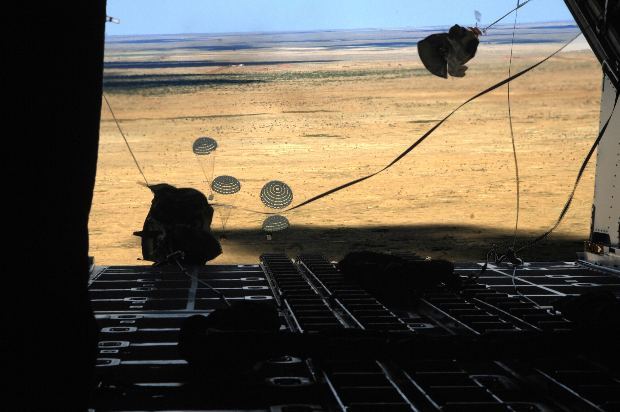 CANNON AIR FORCE BASE N.M.-- Given the green light, loadmasters from the 73rd Special Operations Squadron drop the load over Melrose Air Force Range Sept. 24 aboard the MC-130W Combat Spear aircraft. Flying low and fast enables them to get out of the area quickly and the equipment to ground personnel just as fast. (U.S. Air Force photo by Airman Maynelinne De La Cruz)