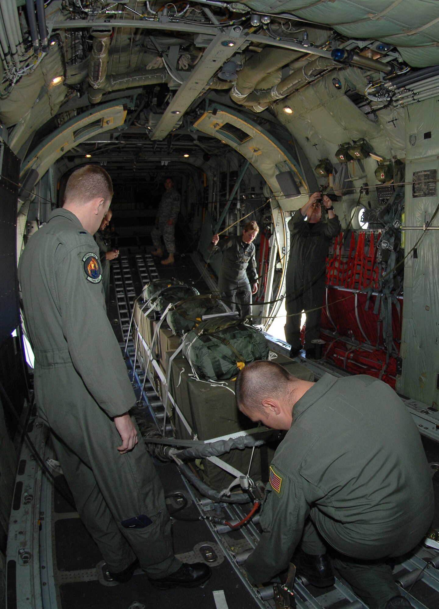 CANNON AIR FORCE BASE N.M.-- Aboard the MC-130W Combat Spear, 1st Lt. Jared Butler and Tech. Sgt. Nicholas Armitage from the 73rd Special Operations Squadron ensure cargo is properly secured. The Airmen performed an air drop Sept. 24, part of their regular training to get equipment to ground forces if an airfield is not available. (U.S. Air Force photo by Airman Maynelinne De La Cruz)