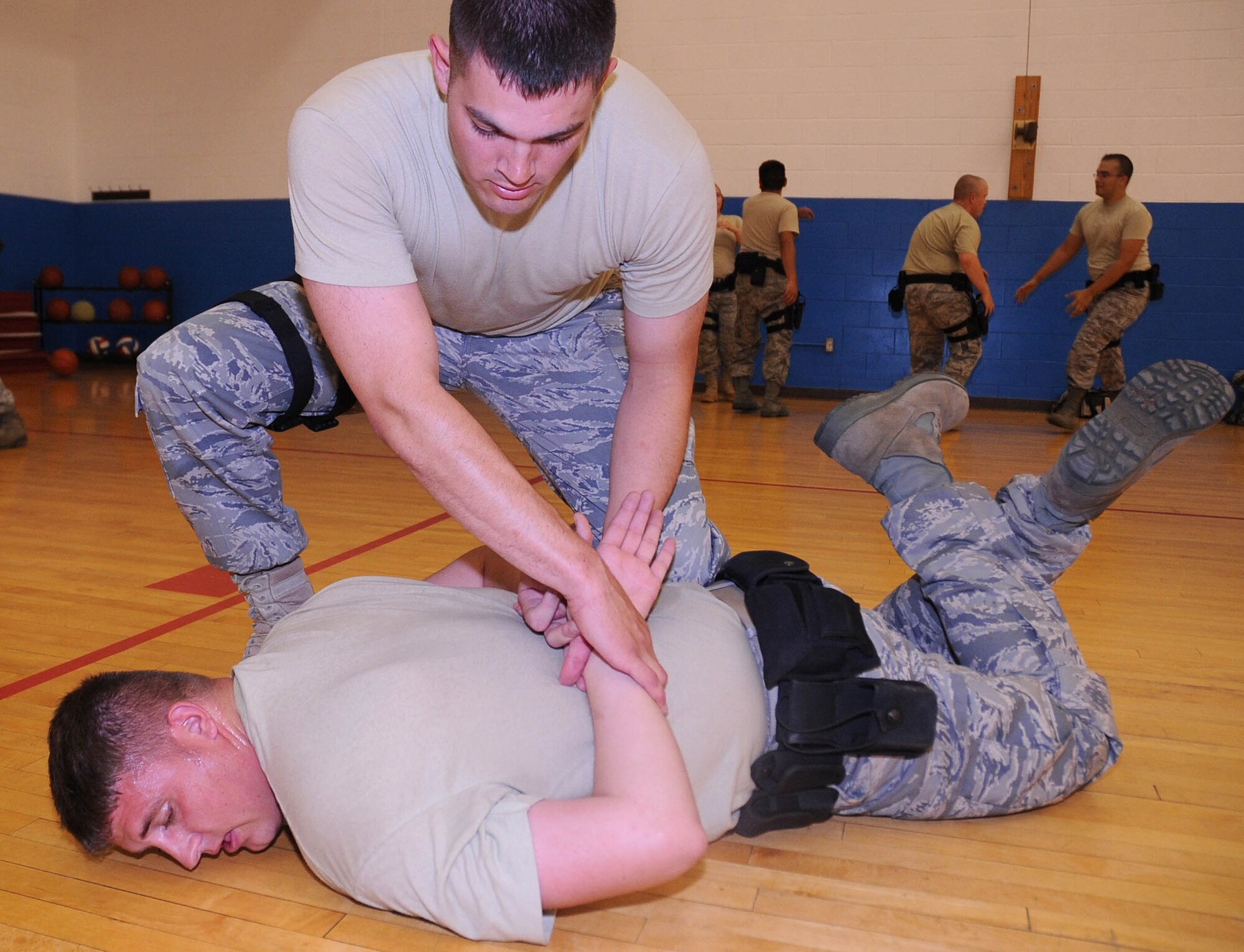 CANNON AIR FORCE BASE, N.M. -- 2nd Lt. Michael Wetlesen (above), 377th Security Forces Squadron, Kirtland AFB, N.M., and Staff Sgt. Charles East, 27th Special Operations Security Forces Squadron, practice take downs and control holds during training Oct. 1. The training provides force-response training that can quickly and accurately be transferred to others. (U.S. Air Force photo/Senior Airman Liliana Moreno)