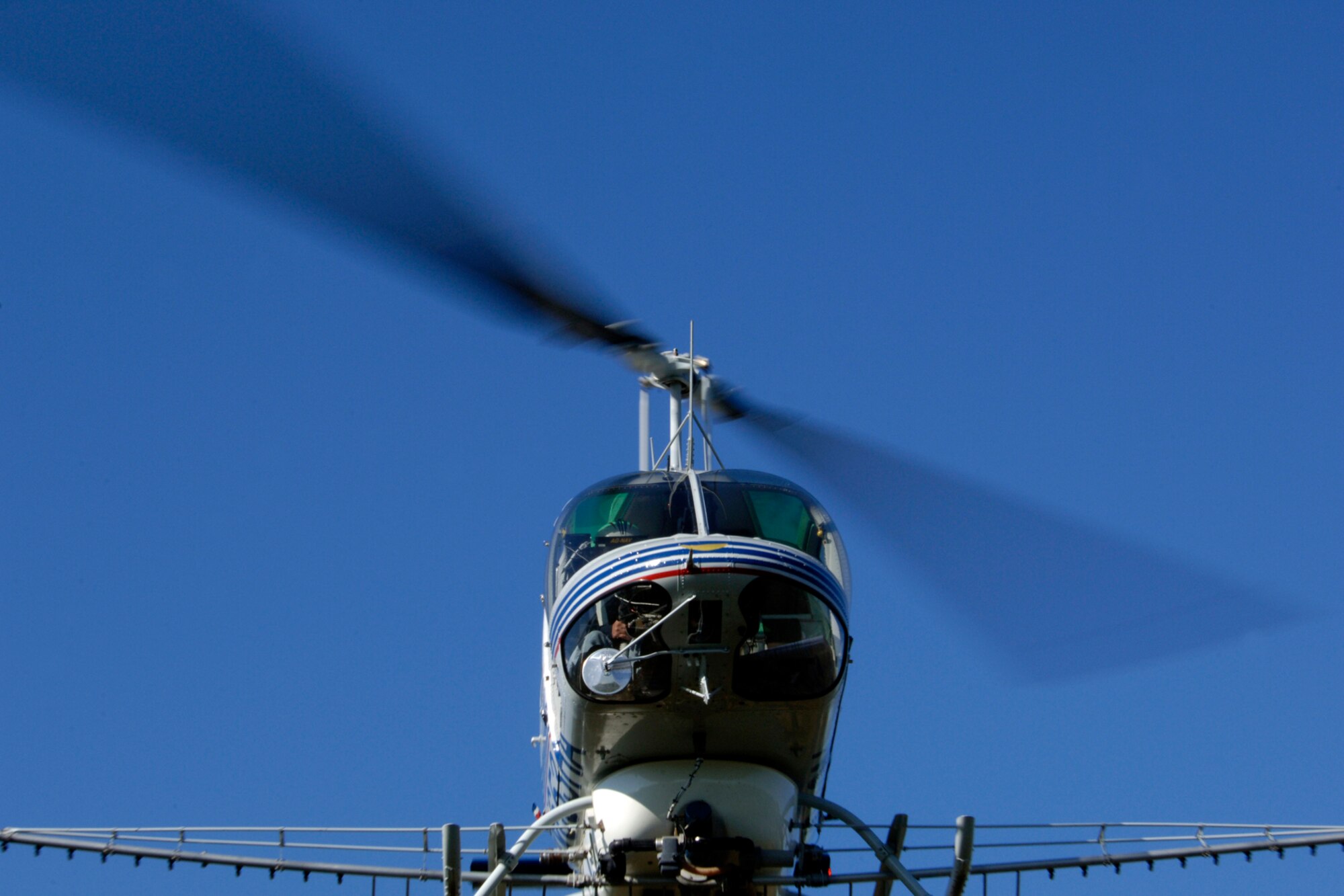 LANGLEY AIR FORCE BASE, Va. -- Brian Redding, a subcontracted pilot, flies a Bell OH 58B helicopter Oct. 2. The helicopter is outfitted with an aerial spray rig in order to spray and kill phragmites. Phragmites are a weed commonly found in marshes that grow fast and can overcome other plants in the area. (U.S. Air Force Photo/Airman 1st Class Jonathan Koob)