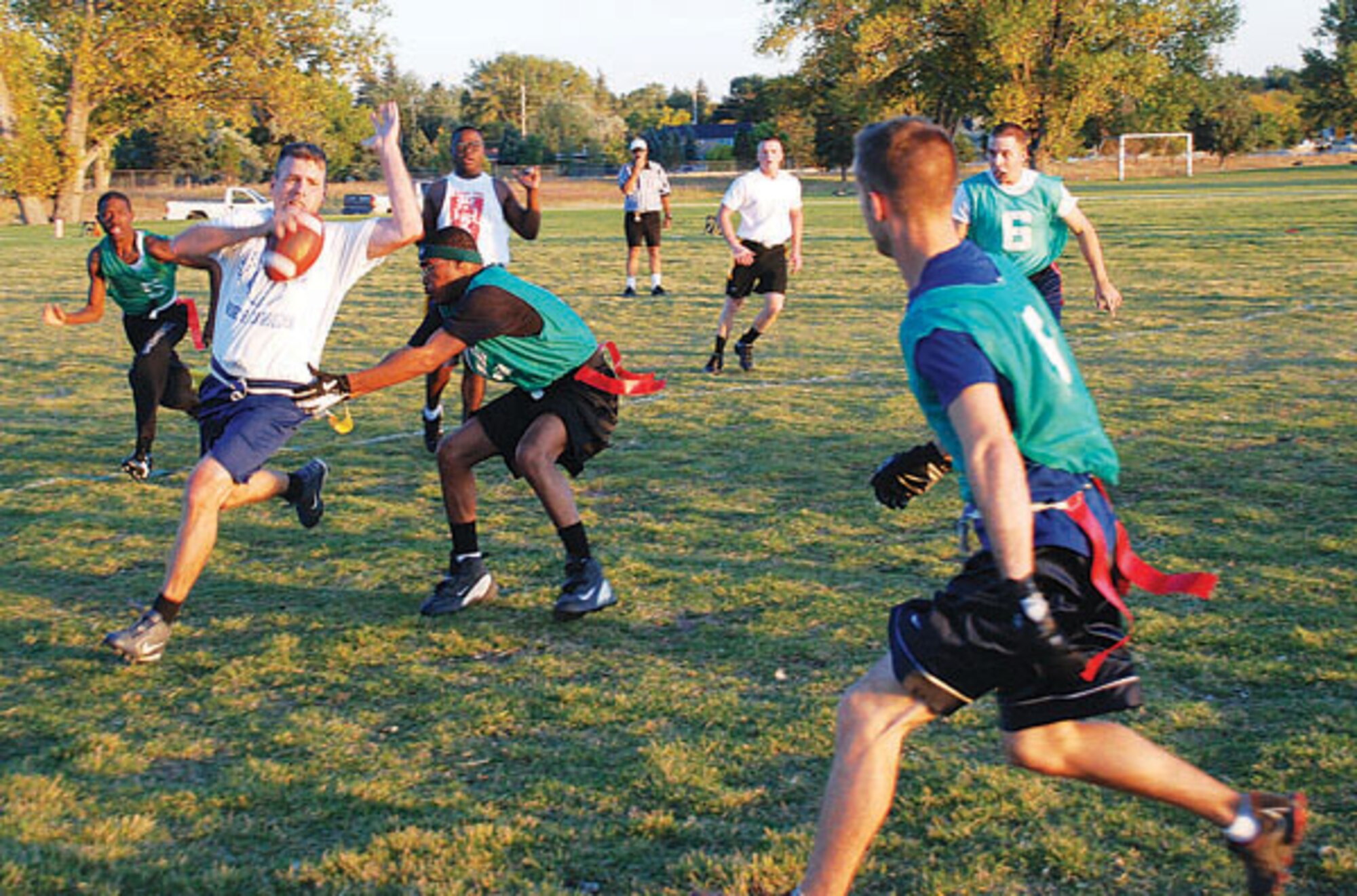Conrad attempts to dodge a flag snatch by the 790th MSFS’s Renardo Haynes. With a quick shuffle, it looked as if Conrad might make it, but Haynes broke him down by a fingernail hold on the flag. (Photo by Airman 1st Class Daryl Knee)