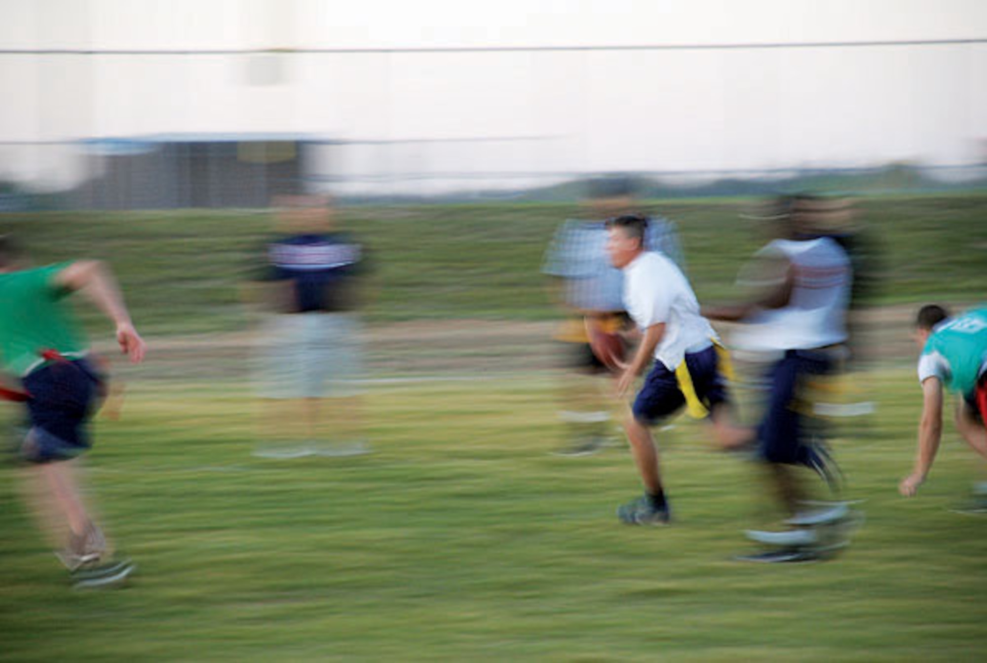 The 790th MSFS’s defense had Conrad’s receivers in a pinch. With the opposing team members closing in, Conrad decided to run the ball himself. (Photo by Airman 1st Class Daryl Knee)