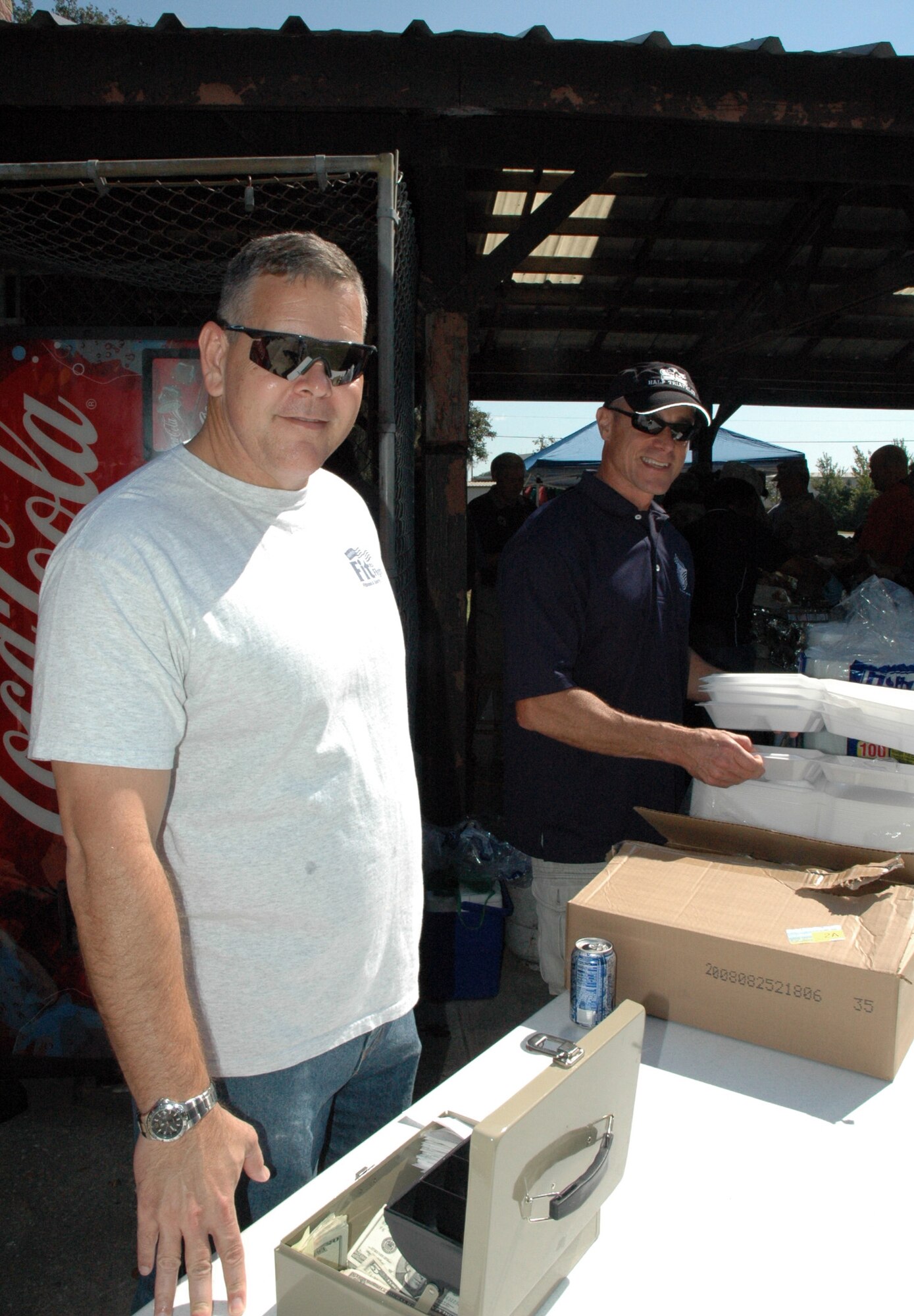 315th Airlift Wing Command Chief Master Sergeant Ben Futrell and 437th Airlift Wing Maintenance Squadron Superintendent Chief Master Sergeant Don Hagen work the till box during the Charleston Chief's Group fish-fryheld here today.  The Charleston Chief's Group has had a cookout fundraiser twice a year for the last 24-years.  Money raised from the event will be distributed back to Team Charleston's airmen through programs that the Chief's Group supports.