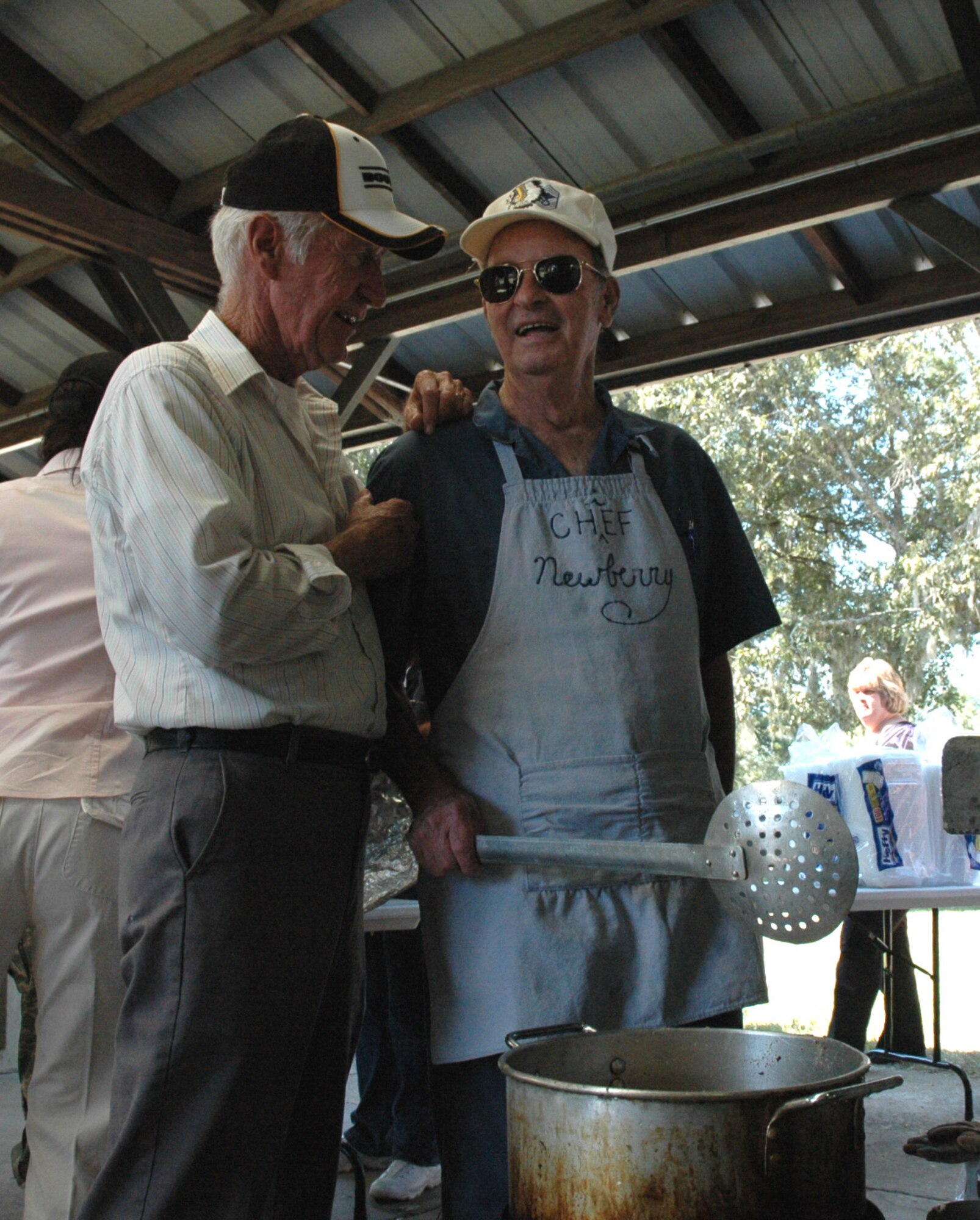 Chief Master Sergeant (ret) Jim Newberry and Chief Master Sergeant (ret) George Shread discuss the finer points of making hushpuppies during the Charleston Chief's Group fish-fryheld here today.  The Charleston Chief's Group has had a cookout fundraiser twice a year for the last 24-years.  Money raised from the event will be distributed back to Team Charleston's airmen through programs that the Chief's Group supports.