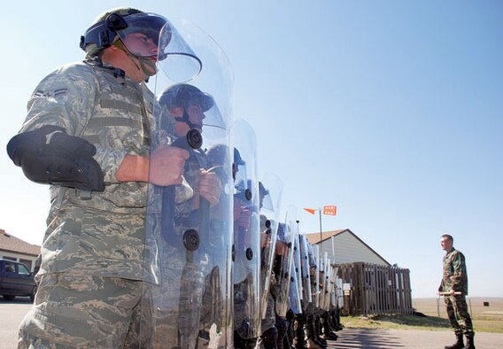 Members of the 90th Security Forces Group ready riot gear for potential protests at Warren missile sites on Sept. 27. The training involved techniques in crowd and riot control while sporting protective gear. Precautions are taken at all times to ensure the safety of missile sites. (Photo by 2nd Lt. Brooke Brzozowske)
