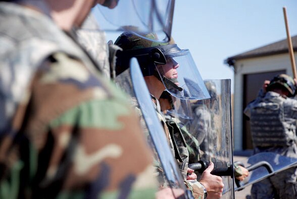 One security forces participant enjoys his training in full riot gear including shoulder and knee pads, face mask and body shield. (Photo by 2nd Lt. Brooke Brzozowske)