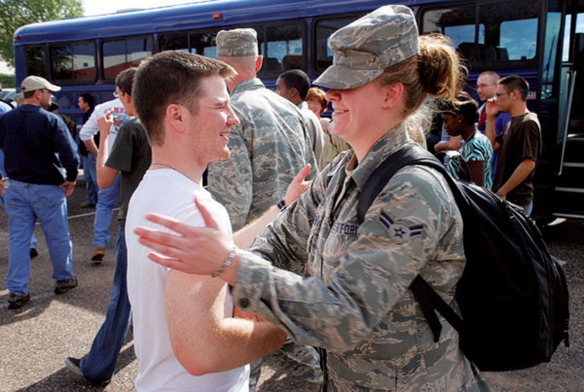 Airman 1st Class Ricky Sherman and Airman 1st Class Jackie Stevenson, both from 90th Logistics Readiness Squadron, greet each other Sept. 21 after a four-month deployment as third-country national escorts. (Photo by Airman 1st Class Daryl Knee)