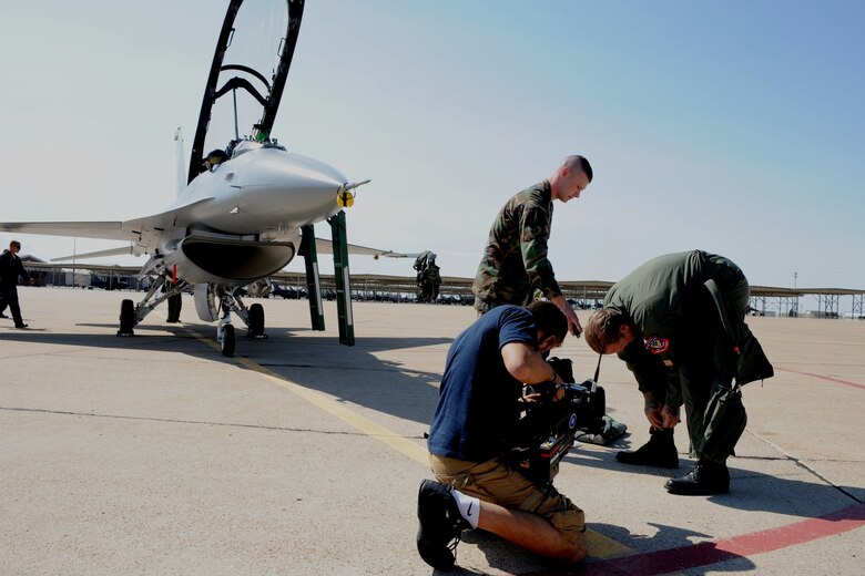 Airman 1st Class Nathan Allison, aircew flight equipment specialist with the 388th Operations Support Squadron, assists Jesse James with his g-suit prior to an F-16 orientation flight Sep. 18. In preparation for the upcoming Spike TV series "Jesse James is a Dead Man," Mr. James flew with the Viper West F-16 demonstration team for a glimpse of the Fighting Falcon's capabilities and the Airmen who prepare it for combat. (U.S. Air Force photo by James Arrowood) 