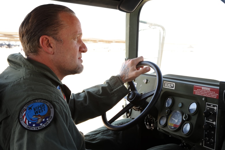 Jesse James of the upcoming Spike TV series "Jesse James is a Dead Man" drives a 729th Air Control Squadron humvee prior to his orientation flight with the Viper West F-16 demonstration team Sep. 18. The flight aims to give Mr. James and his viewers a taste of the Fighting Falcon's capabilities and the Airmen who prepare it for combat. (U.S. Air Force photo by James Arrowood) 