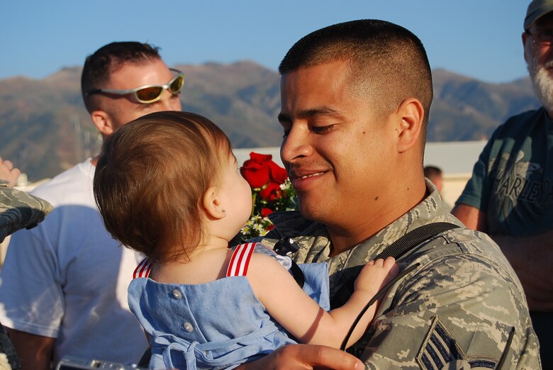 Staff Sgt. Ramon Escobedo greets a loved one Sep. 22 during the 729th Air Control Squadron's Hill AFB homecoming. In May, over 200 Airmen from the unit deployed to Joint Base Balad, Iraq to provide radar air surveillance and command and control of coalition aircraft for combatant commanders. During the four-month rotation, the 729th ACS' air battle managers and support personnel alongside its ground radar and tactical vehicle equipment controlled over 277,000 square miles of Iraq’s airspace for over 3,000 hours. (Photo by 1st Lt. Beth Woodward)  