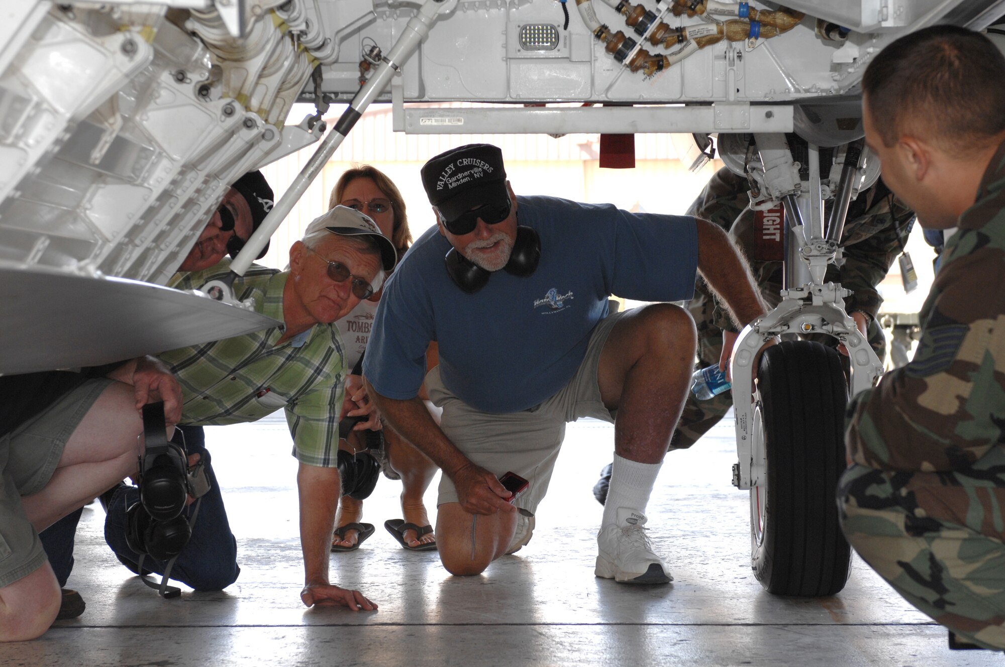 Former crew chiefs from the 8th Fighter Squadron check out the undercarriage of the F-22A Raptor during a static display at Holloman Air Force Base, N.M., September 26. The six veterans received a base tour which included the F-22 viewing. They all worked together in 1968 when the 8 FS was relocated from Spangdahlem Air Base, Germany, to Holloman, and were visiting as part of its 40 year reunion. (U.S. Air Force photo/Airman Sondra M. Escutia)