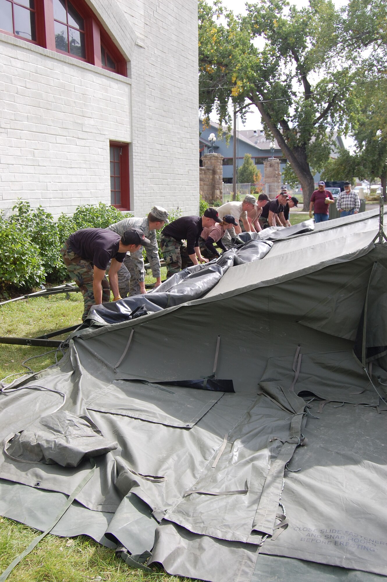 About a dozen members of the 341st Civil Engineer Squadron volunteered their time and effort to assemble military tents at the Great Falls Fair Grounds Sept. 25.  The tents and volunteers came from Malmstrom Air Force Base to support the second annual “Stand Down,” an event geared toward helping homeless veterans receive free medical check-ups, military clothing and supplies, and a free meal.    (U.S. Air Force photo/Senior Airman Eydie Sakura)