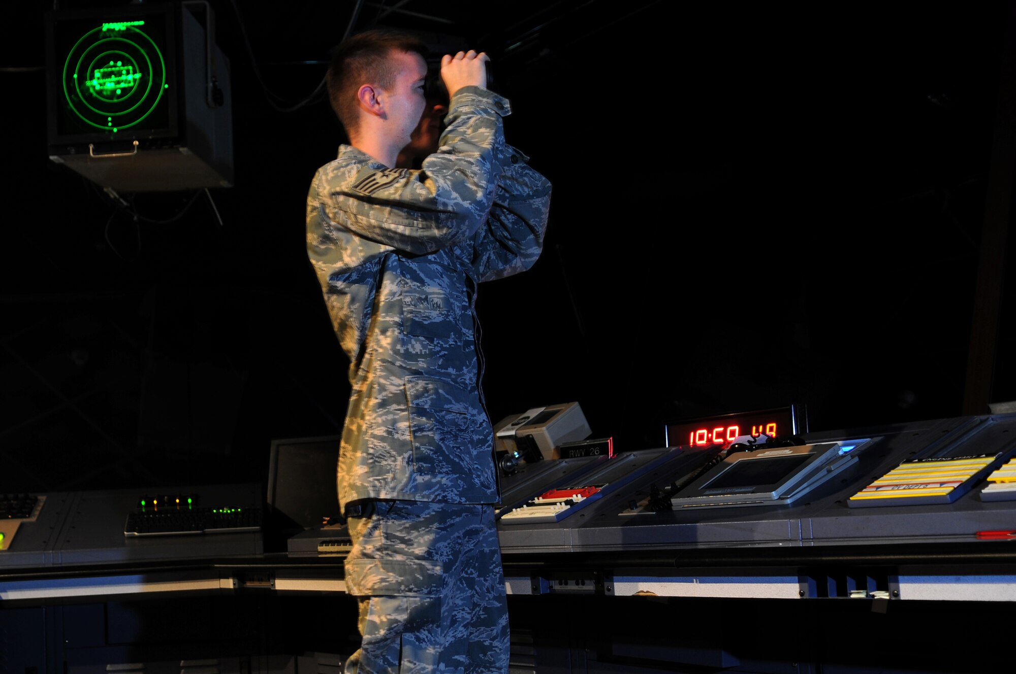 United States Air Force Staff Sgt. Dustin P. Mc Cabe,86th Operation Support Squadron, waits on an incoming C-130 Hercules to land on the flight line Ramstein Air Base,Germany, Sept. 30, 2008. The 86th OSS ensure that all inbound and outbound flights are safe and secure for landing or take-offs. (U.S. Air Force photo by Airman 1st Class Grovert Fuentes)(Released)*