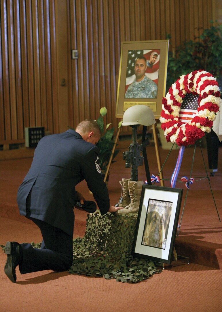 9/26/2008 - Master Sgt. Anson Wiltse, 341st Training Squadron, takes a moment to remember Sergeant Greg Rodriguez Sept. 26 at the Hope Chapel. Sergeant Rodriguez, a former handlers course student and Specialized Seach Dog Course instructor, was killed in the line of duty while serving in Afghanistan. (USAF photo by Robbin Cresswell)